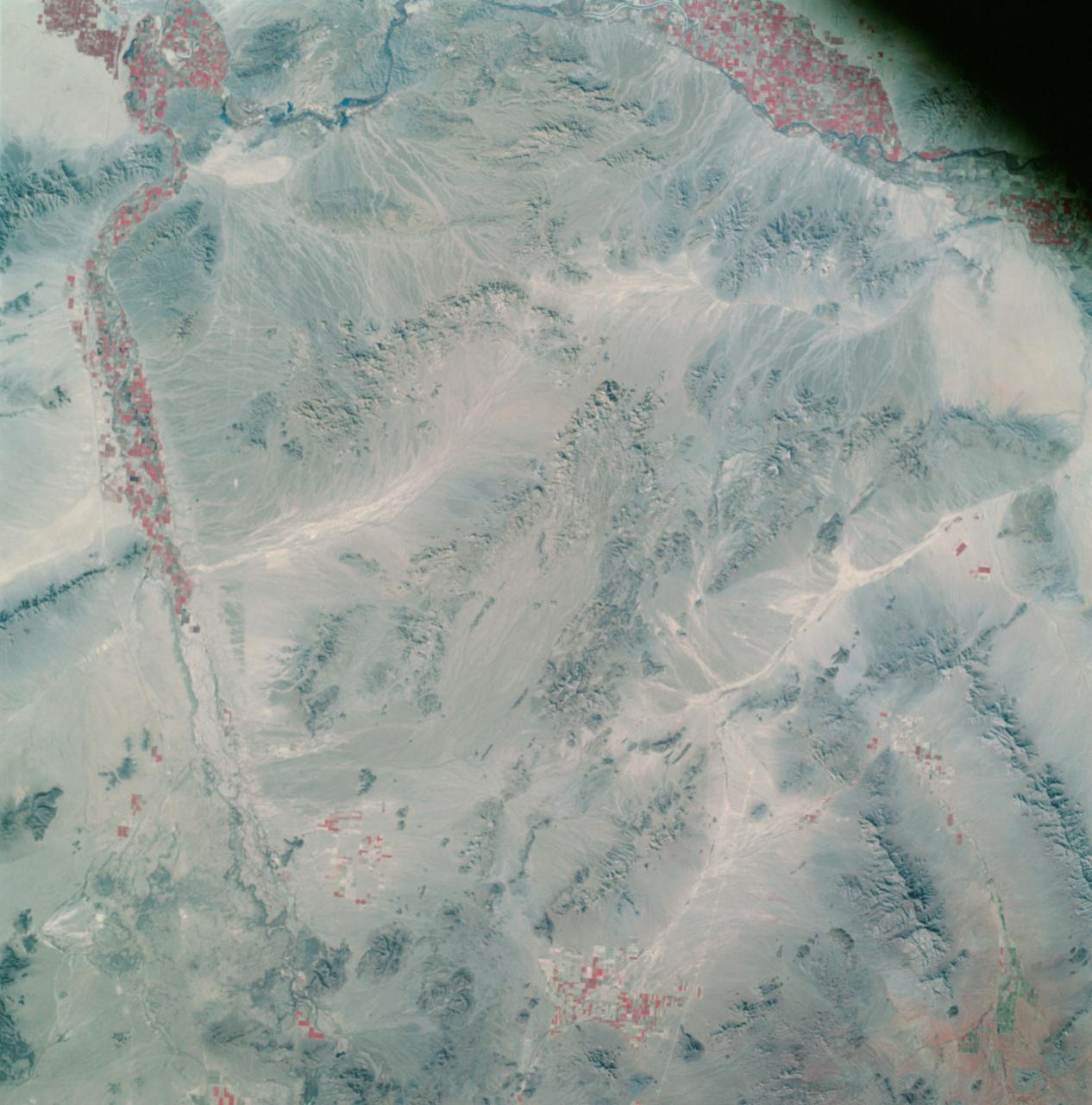 AS09-26A-3800A (12 March 1969) --- Color infrared photograph of southwestern Arizona, Yuma-Gila Desert-Gila River-Colorado River area, taken on March 12, 1969, by one of the four synchronized cameras of the Apollo 9 Earth Resources Survey SO65 Experiment. At 11:28 a.m. (EST) when this picture was made the Apollo 9 spacecraft was at an altitude of 128 nautical miles, and the sun elevation was 30 degrees above the horizon. The location of the point on Earth's surface at which the four-camera combination was aimed 33 degrees 19 minutes north latitude, and 113 degrees 45 minutes west longitude. The other three cameras used: (B) black and white film with a red filter; (C) black and white infrared film; and (D) black and white film with a green filter.