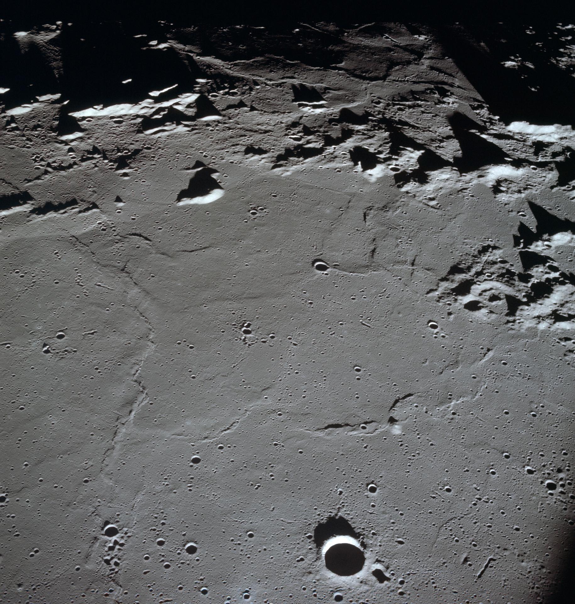 View of the pockmarked Apollo Landing Site 3 on the Moon as seen from orbit.