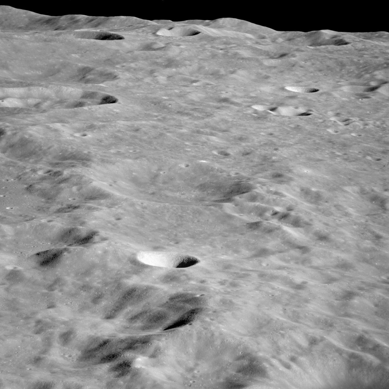 AS10-34-5173 (18-26 May 1969) --- An Apollo 10 photograph of the lunar farside showing an area in the vicinity of International Astronomical Union (I.A.U.) crater No. 300, taken from the Command and Service Modules. This view is looking south over typical rugged lunar terrain. I.A.U. crater No. 300 is located at 155 degrees east longitude and 10 degrees south latitude.