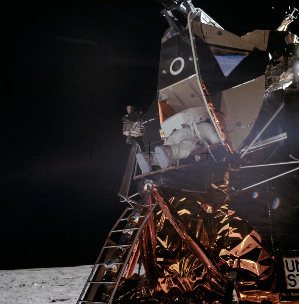 AS11-40-5863 (20 July 1969) --- Astronaut Edwin E. Aldrin Jr., lunar module pilot, is photographed egressing the Lunar Module (LM) during the Apollo 11 extravehicular activity (EVA) on the moon. This photograph was taken by astronaut Neil A. Armstrong, commander, with a 70mm lunar surface camera. While astronauts Armstrong and Aldrin descended in the Lunar Module (LM) "Eagle" to explore the Sea of Tranquility region of the moon, astronaut Michael Collins, command module pilot, remained with the Command and Service Modules (CSM) "Columbia" in lunar orbit.