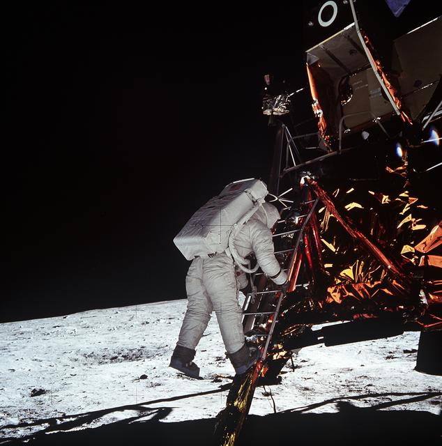 Astronaut Edwin Aldrin descends steps of Lunar Module ladder to walk on moon