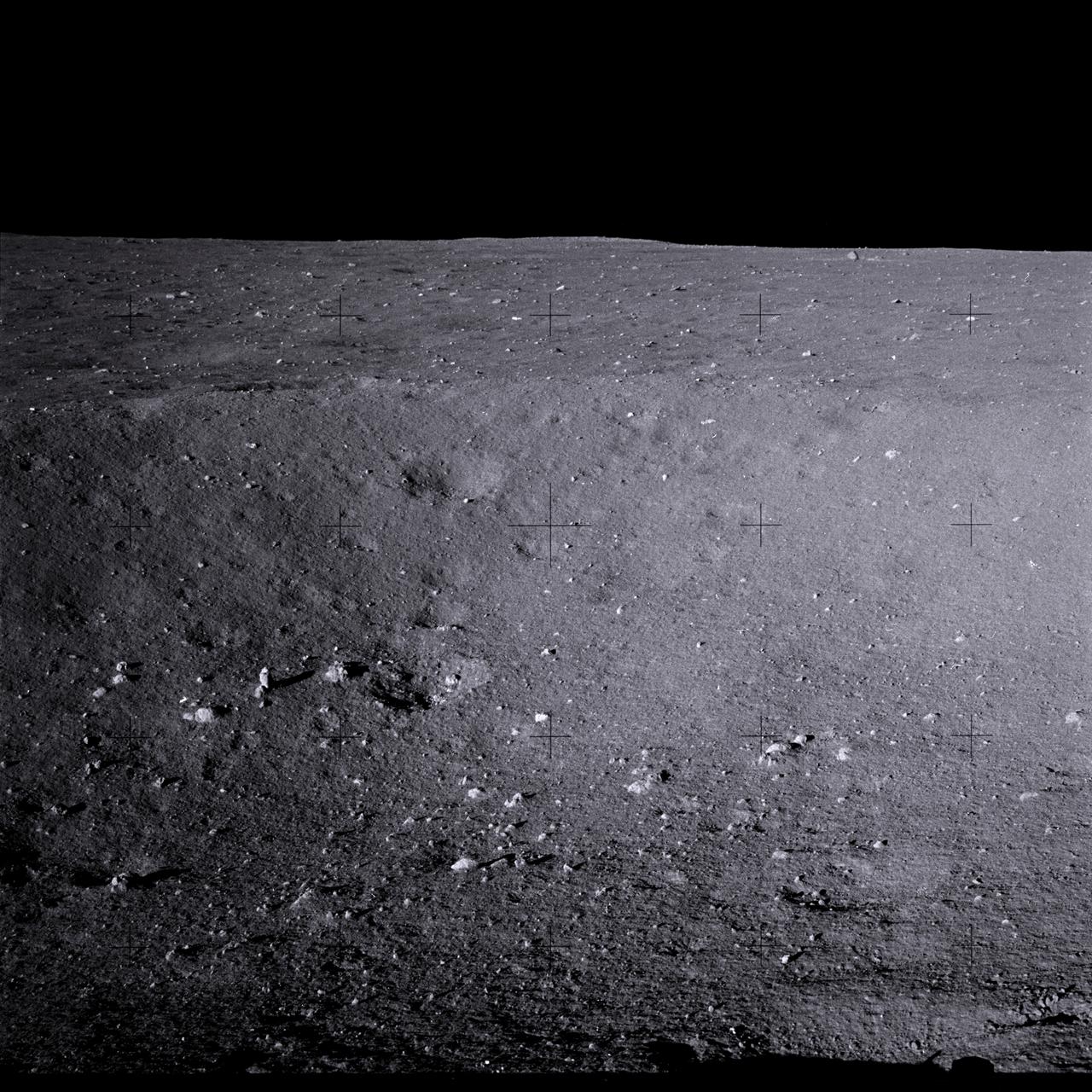 AS11-40-5881 (20 July 1969) --- This 70mm handheld camera's image on the Sea of Tranquility's lunar surface is the first of a multi-framed panorama photographed from a point some 30 or 40 feet west of the plus-Z (west) footpad of the Lunar Module "Eagle." The view is looking toward the southwest showing part of the horizon crater rim that was pointed out as being visible from the Eagle's window.