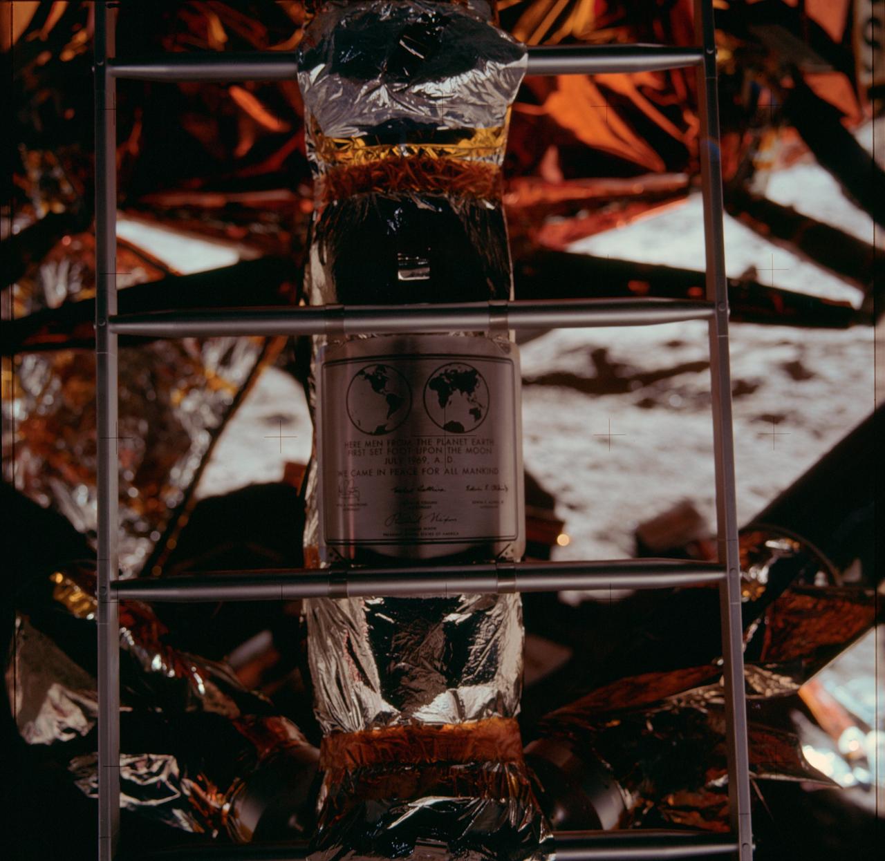 AS11-40-5899 (20 July 1969) --- Close-up view of the plaque which the Apollo 11 astronauts left on the moon in commemoration of the historic lunar landing mission. The plaque was attached to the ladder on the landing gear strut on the descent stage of the Apollo 11 Lunar Module (LM). The plaque was covered with a thin sheet of stainless steel during flight. Astronaut Michael Collins, command module pilot, remained with the Command and Service Modules (CSM) in lunar orbit while astronauts Neil A. Armstrong, commander, and Edwin E. Aldrin Jr., lunar module pilot, explored the moon.