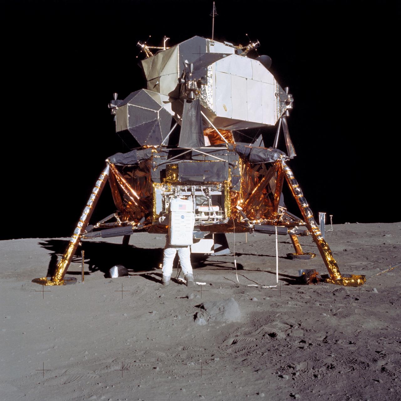 AS11-40-5927 (20 July 1969) --- Astronaut Edwin E. Aldrin Jr., lunar module pilot, prepares to deploy the Early Apollo Scientific Experiments Package (EASEP) during the Apollo 11 lunar surface extravehicular activity (EVA). Astronaut Neil A. Armstrong, commander, took this picture with a 70mm lunar surface camera. During flight the EASEP is stowed in the Lunar Module's (LM) scientific equipment bay at the left year quadrant of the descent stage looking forward. Aldrin is removing the EASEP from its stowed position. Photo credit: NASA