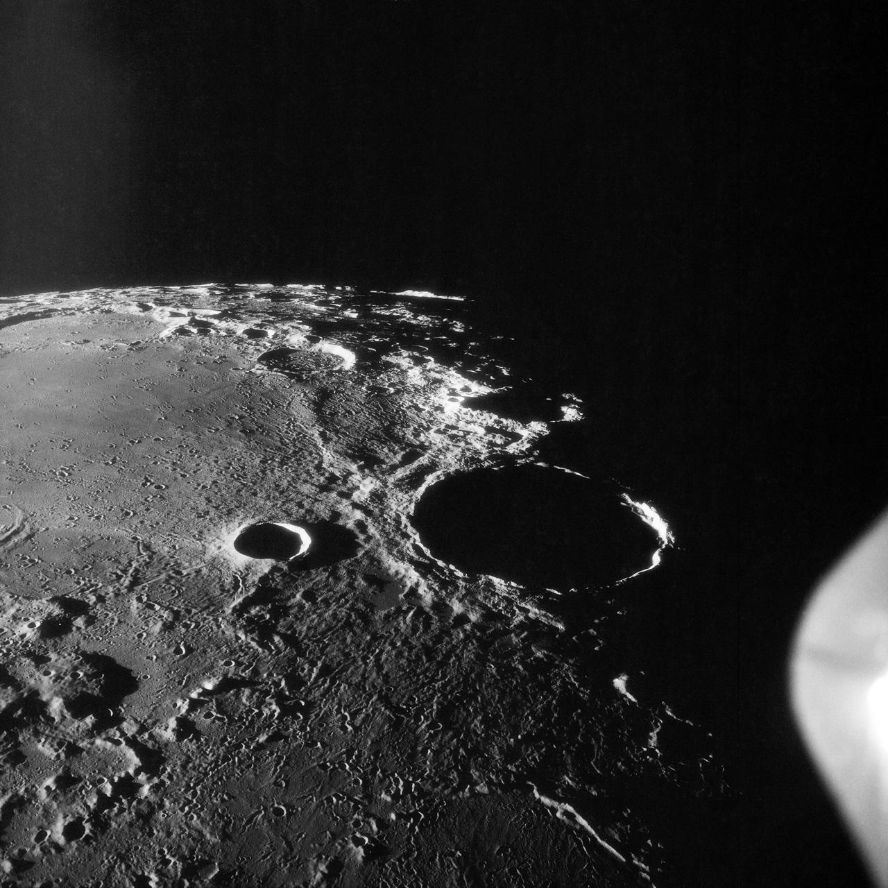 AS11-42-6237 (20 July 1969) --- An Apollo 11 oblique view of the large crater Theophilus located at the northwest edge of the Sea of Nectar on the lunar nearside. Theophilus is about 60 statute miles in diameter. The smooth area is Mare Nectaris. The smaller crater Madler, about 14 statute miles in diameter, is located to the east of Theophilus. Visible in the background are the large crater Fracastorius and the smaller crater Beaumont. The coordinates of the center of this photograph are 29 degrees east longitude and 11 degrees south latitude.