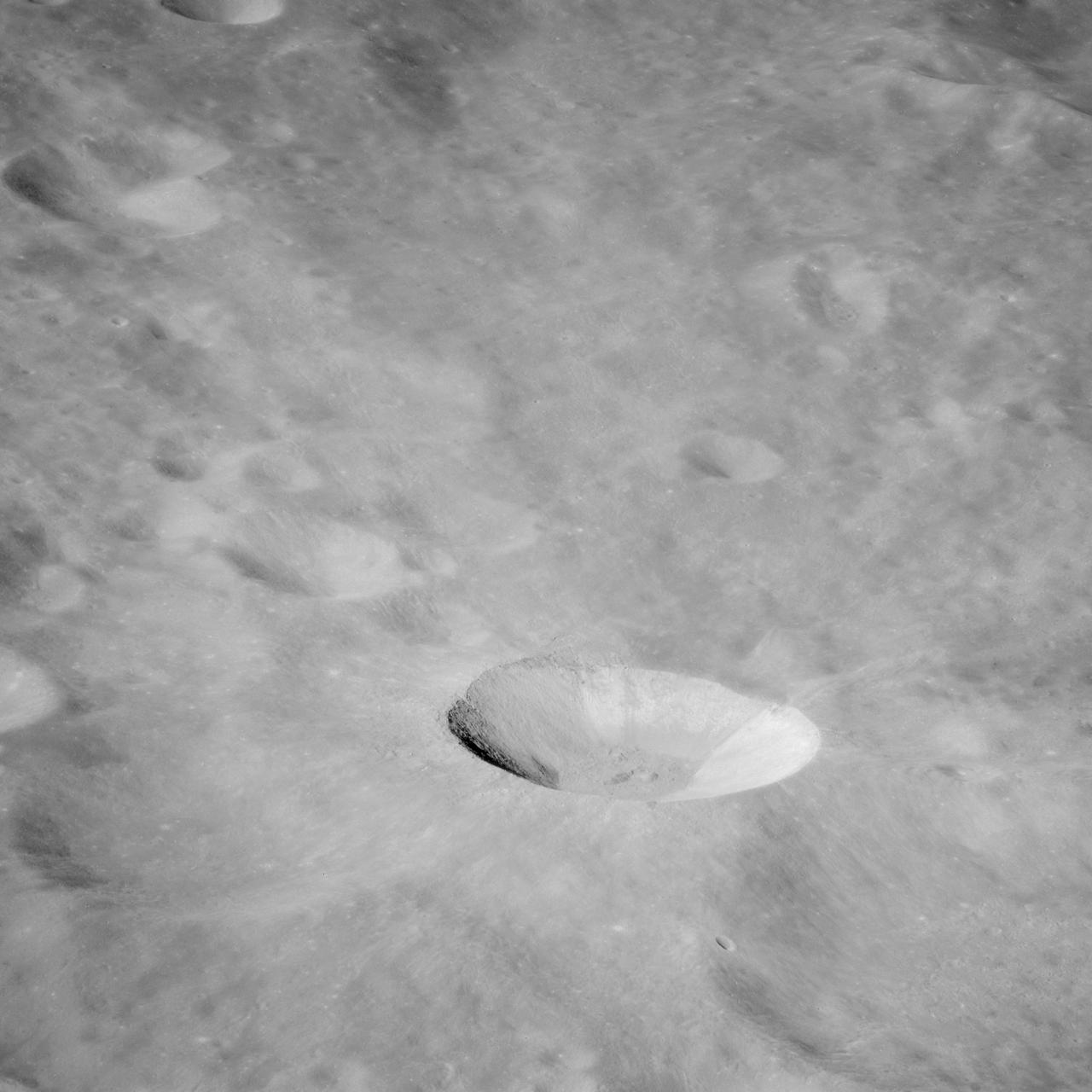 AS11-43-6412 (July 1969) --- This is a northeasterly, low-oblique view of an unmanned crater and highland area on the lunar farside, as photographed from Apollo 11. The center of the picture is located at the 167 degrees east longitude and 6 degrees north latitude. This area of the moon lies just east of International Astronomical Union crater No. 220.