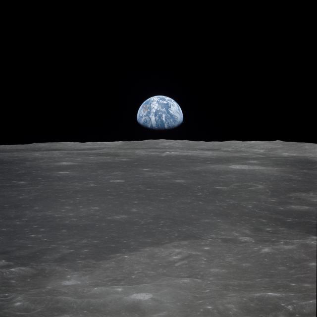 NASA image: Apollo 11 Mission image - View of moon limb,with Earth on the horizon,Mare Smythii Region