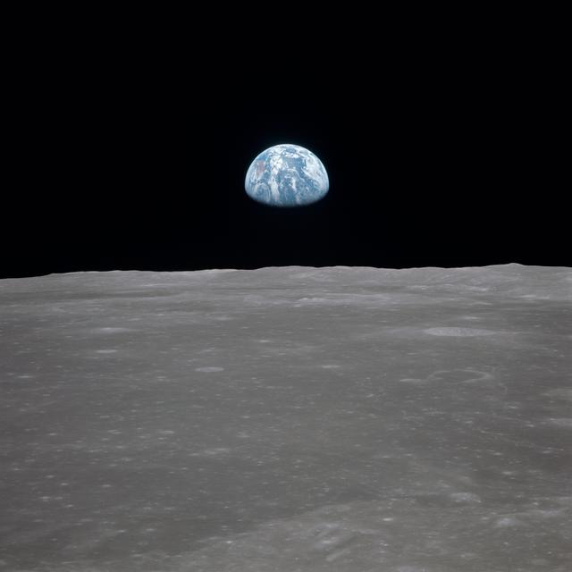 NASA image: Apollo 11 Mission image - View of moon limb,with Earth on the horizon,Mare Smythii Region