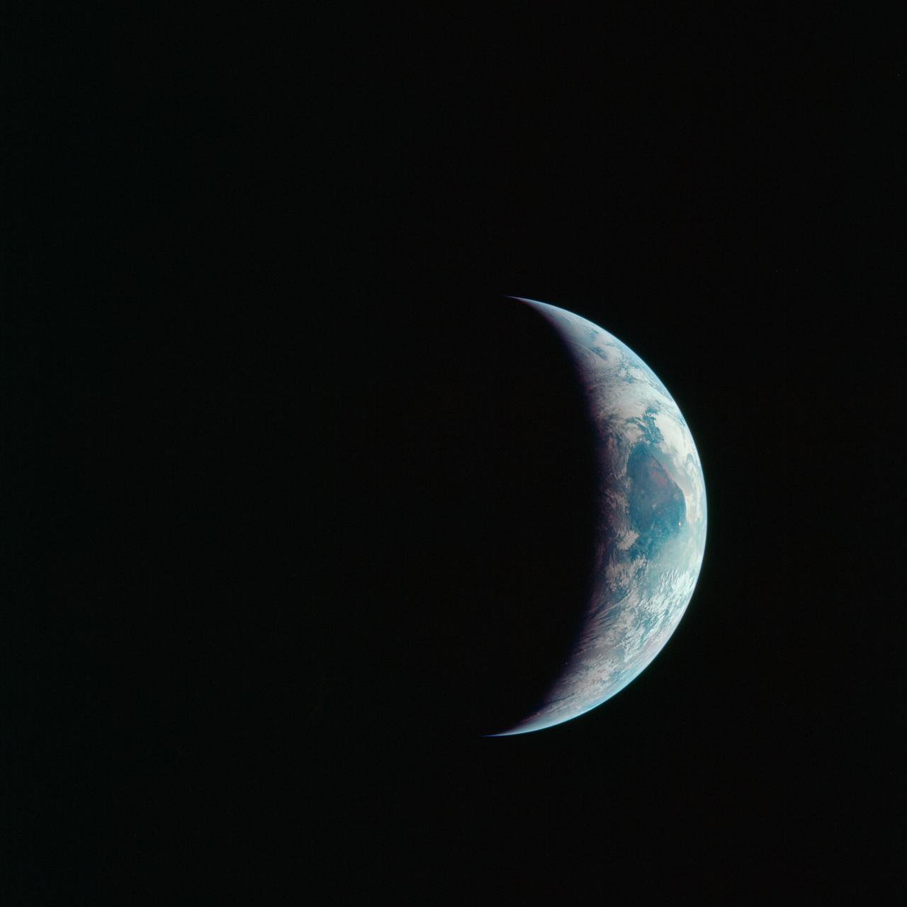 AS11-44-6689 (16-24 July 1969) --- One-third of the Earth's sphere illuminated, Earth's terminator, sunglint, a portion of east Africa, as photographed from the Apollo 11 spacecraft during its first lunar landing mission. While astronauts Neil A. Armstrong, commander, and Edwin E. Aldrin Jr., lunar module pilot, descended in the Lunar Module (LM) "Eagle" to explore the Sea of Tranquility region of the moon, astronaut Michael Collins, command module pilot, remained with the Command and Service Modules (CSM) "Columbia" in lunar orbit.