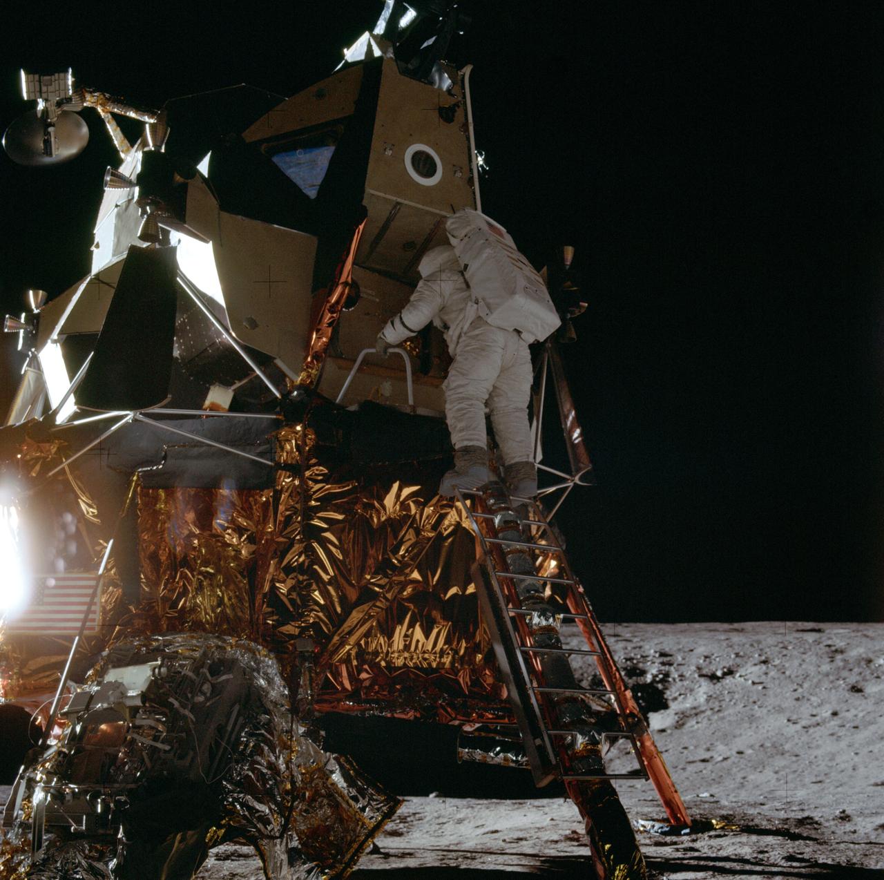 AS12-46-6726 (19 Nov. 1969) --- Astronaut Alan L. Bean, lunar module pilot for the Apollo 12 mission, starts down the ladder of the Lunar Module (LM) to join astronaut Charles Conrad Jr., mission commander, in extravehicular activity (EVA). While astronauts Conrad and Bean descended in the LM "Intrepid" to explore the Ocean of Storms region of the moon, astronaut Richard F. Gordon Jr., command module pilot, remained with the Command and Service Modules (CSM) "Yankee Clipper" in lunar orbit.