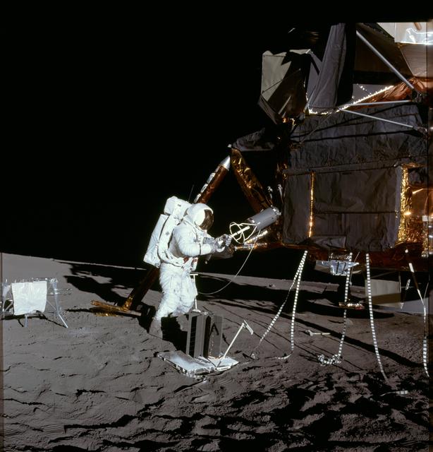 NASA image: Apollo 12 Mission image - Alan Bean unloads ALSEP RTG fuel element 