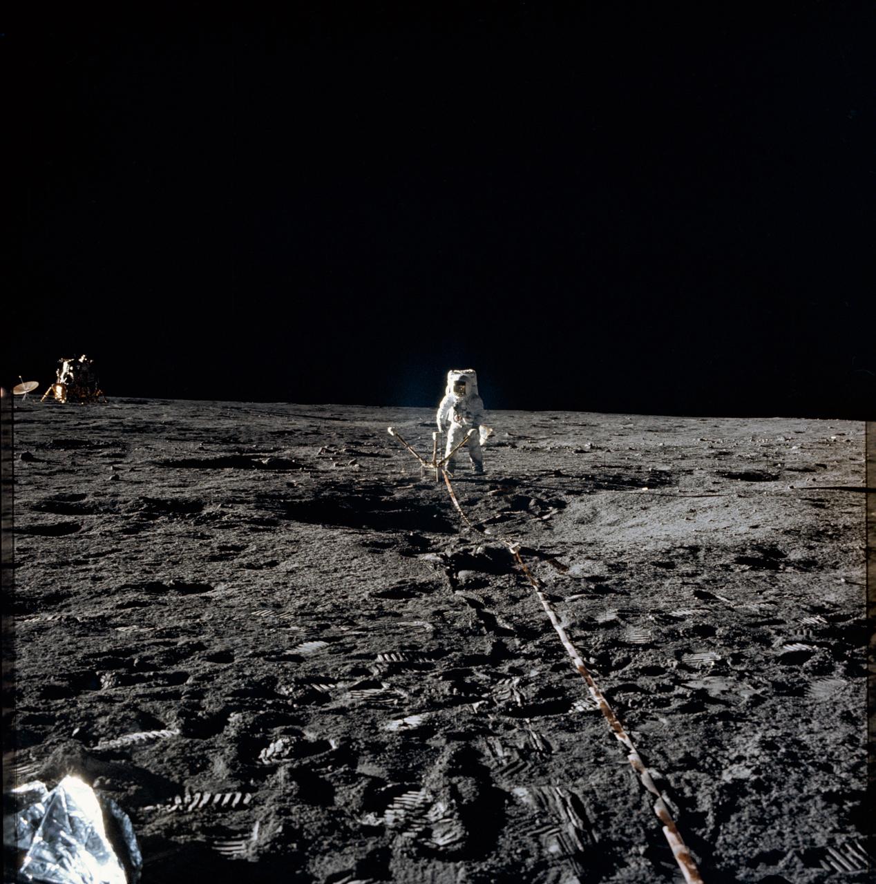 Astronaut Alan L. Bean, lunar module pilot, deploys the Lunar Surface Magnetometer (LSM) during the first Apollo 12 extravehicular activity on the Moon. The LSM is a component of the Apollo Lunar Surface Experiments Package (ALSEP). The Lunar Module can be seen in the left background.