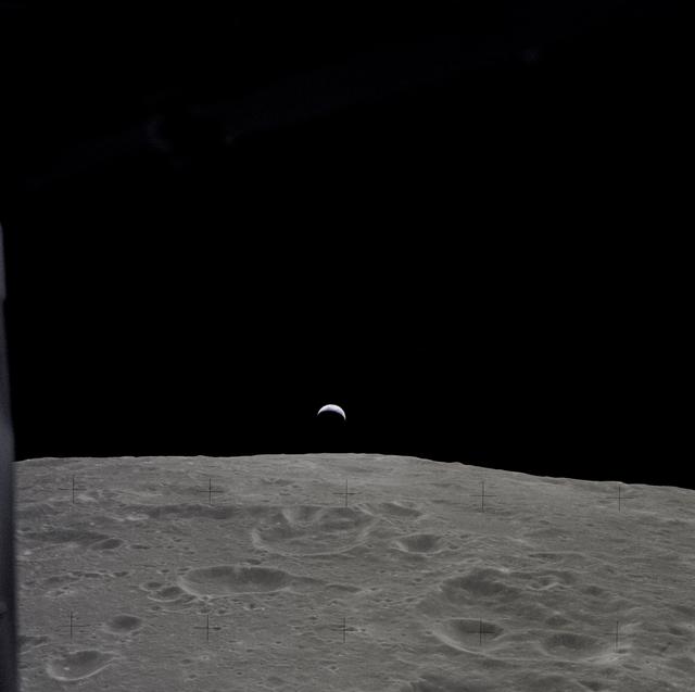 NASA image: Earth rises above the lunar horizon as seen from Apollo 12 in lunar orbit