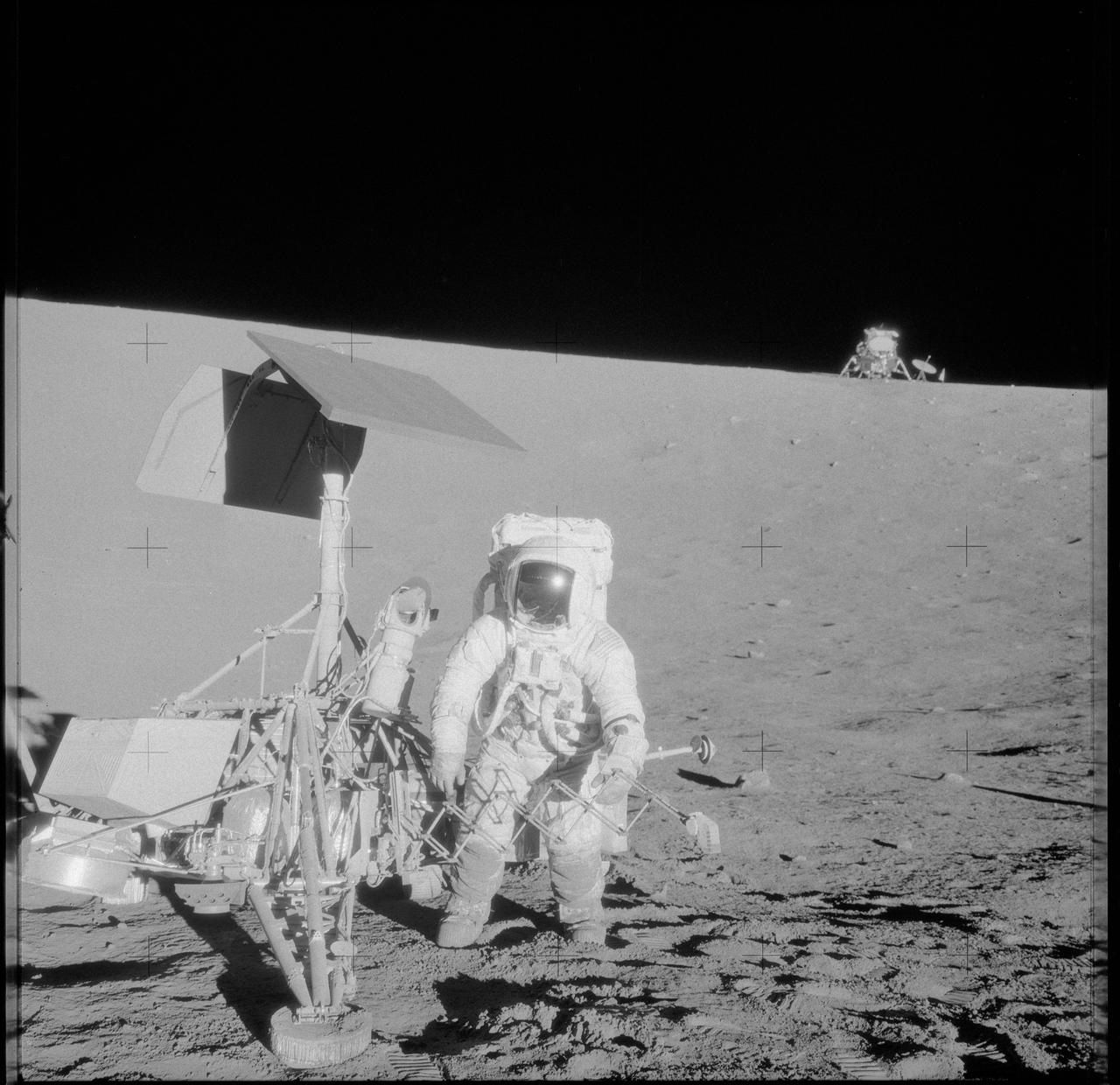 AS12-48-7136 (20 Nov. 1969) --- Astronaut Charles Conrad Jr., commander, examines the unmanned Surveyor 3 spacecraft during the second Apollo 12 extravehicular activity (EVA).  In the background is the lunar module, parked where the crew had landed it in the Ocean of Storms only 600 feet from Surveyor 3. This series of pictures documents the only occasion wherein Apollo astronauts landed near or had hands-on contact with another spacecraft which had arrived on the moon's surface well ahead of them. This picture was taken by astronaut Alan L. Bean, lunar module pilot.  The television camera and several other pieces were taken from Surveyor 3 and brought back to Earth for scientific examination. Surveyor 3 soft-landed on the moon on April 19, 1967. Astronaut Richard F. Gordon Jr., command module pilot, remained with the Command and Service Modules (CSM) in lunar orbit while astronauts Conrad and Bean descended in the LM to explore the moon. Photo credit: NASA