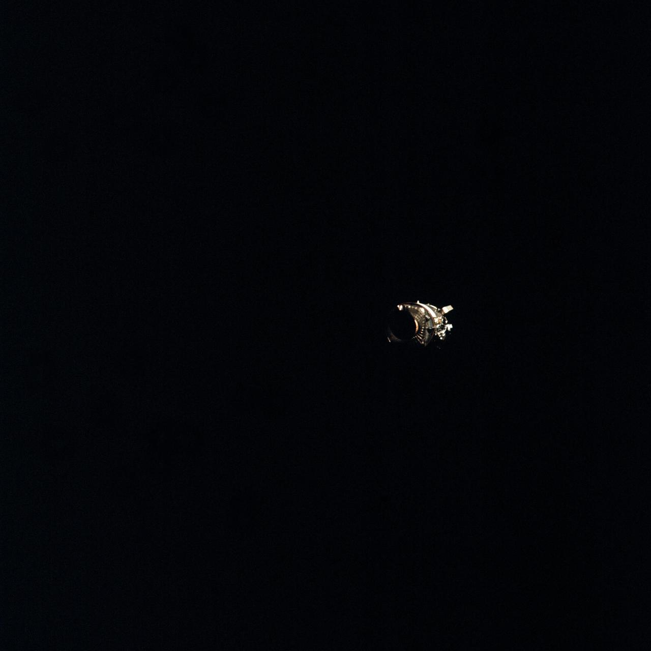 AS13-58-8458 (17 April 1970) --- This view of the severely damaged Apollo 13 Service Module (SM) was photographed from the Lunar Module/Command Module (LM/CM) following SM jettisoning. An entire SM panel was blown away by the apparent explosion of oxygen tank number two. Two of the three fuel cells are visible at the forward portion of the opening. The hydrogen tanks are located in Sector 4 of the Apollo 13 SM. The apparent rupture of the oxygen tank caused the Apollo 13 crew members to use the LM as a "lifeboat." The LM was jettisoned just prior to Earth re-entry by the CM.