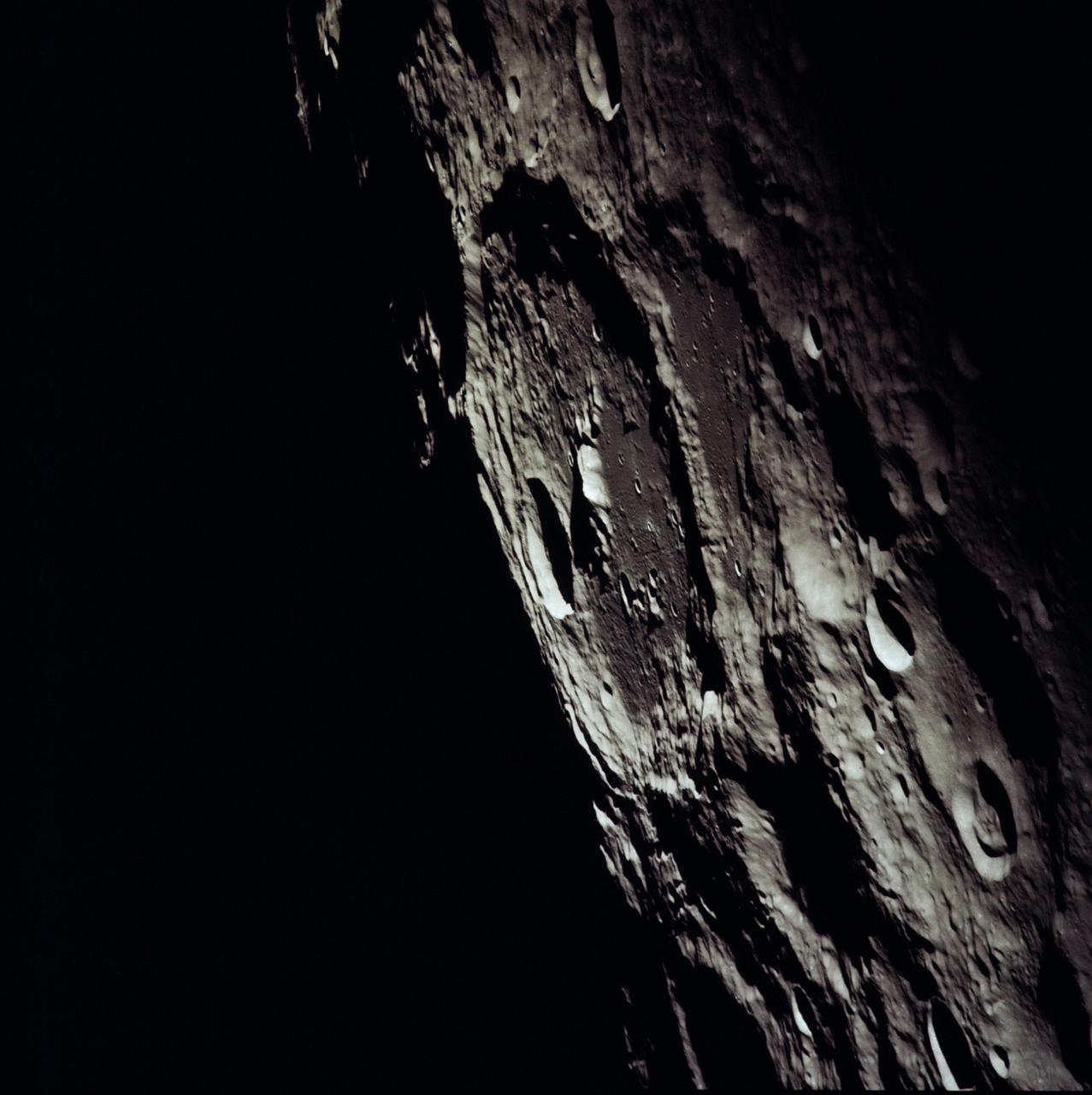 AS13-60-8635 (April 1970) --- An oblique view of the International Astronomical Union Crater No. 302 on the lunar farside as photographed from the Apollo 13 spacecraft during its pass around the moon. This large crater is located at 162 degrees east longitude and 10 degrees south latitude. The smaller crater, I.A.U. No. 301, is in the foreground. I.A.U. No. 302 has ridges in its center and a smaller crater near its inner edge. This view is looking southeast.