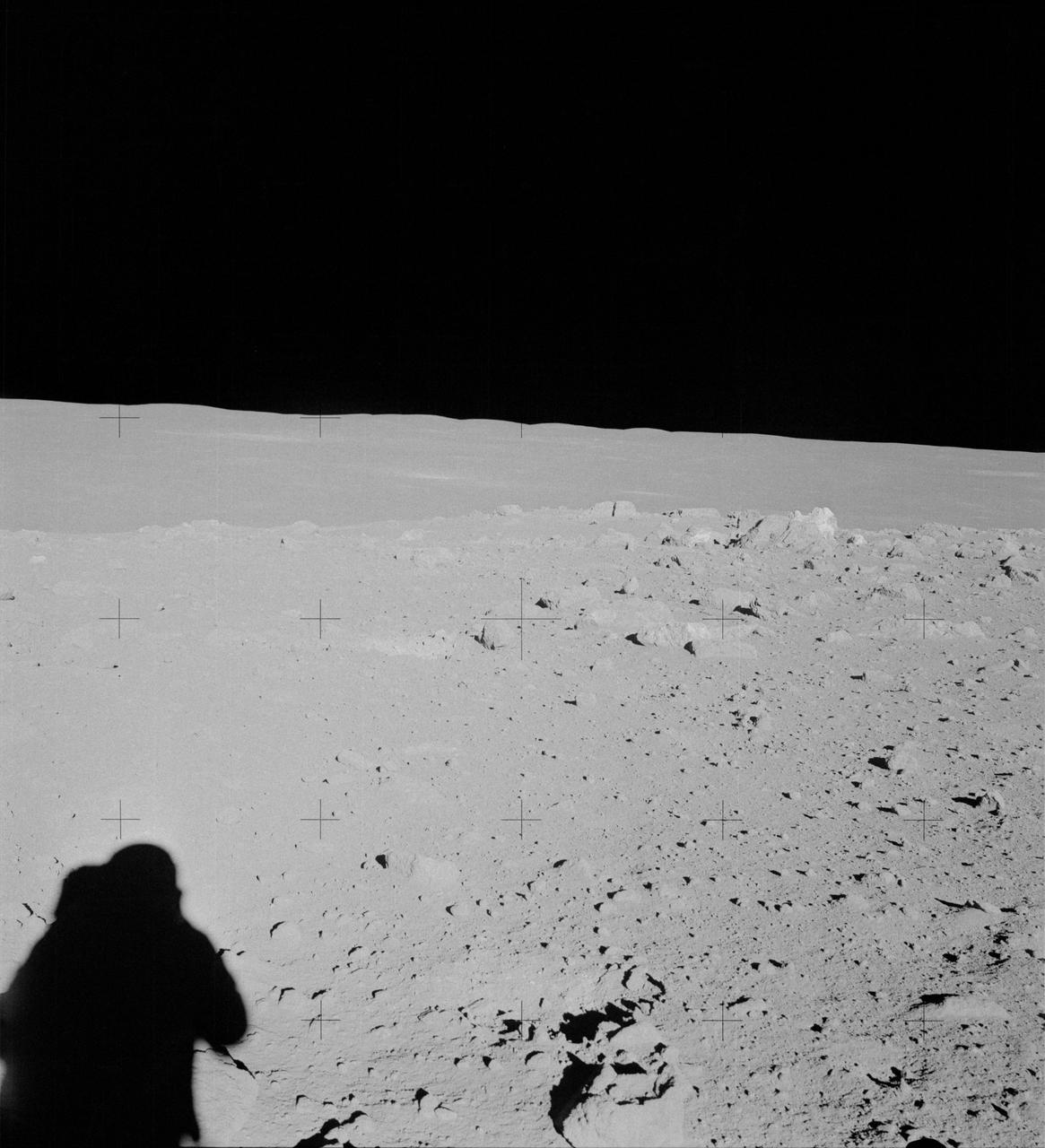 AS14-64-9099 (6 Feb. 1971) --- An Apollo 14 crew member (note shadow) photographs this field of boulders located on the flank of Cone Crater during the second extravehicular activity (EVA). This view is looking just north of west. While astronauts Alan B. Shepard Jr., commander, and Edgar D. Mitchell, lunar module pilot, were exploring the moon, astronaut Stuart A. Roosa, command module pilot, was maneuvering the Apollo 14 Command and Service Modules (CSM) in lunar orbit.