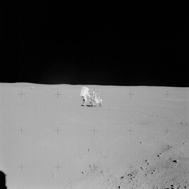 NASA image: Apollo 14 Mission image - View of Astronaut Mitchell and the Modular Equipment Transporter with the Lunar Module in background. 