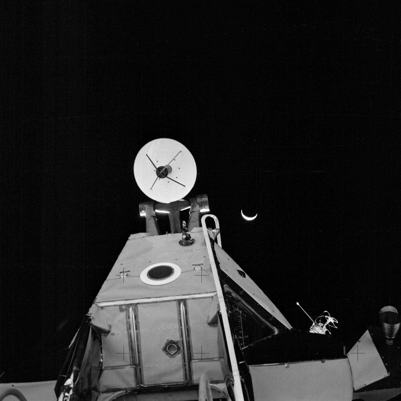 AS14-64-9193 (5 Feb. 1971) --- A close-up view of the forward section of the Apollo 14 Lunar Module (LM) ascent stage, looking upward from the LM ladder. This photograph was taken by one of the Apollo 14 astronauts at the close of their first extravehicular activity (EVA). The LM's ingress/egress hatch is just out of view at the bottom, near center. At the top center is the rendezvous radar antenna. An RCS thruster is visible at the far right. One of the two VHF antennas is on the right. The LM's optical alignment telescope is located at the black circle which has a wide, white ring around it. The crescent Earth can be seen in the far distant background.