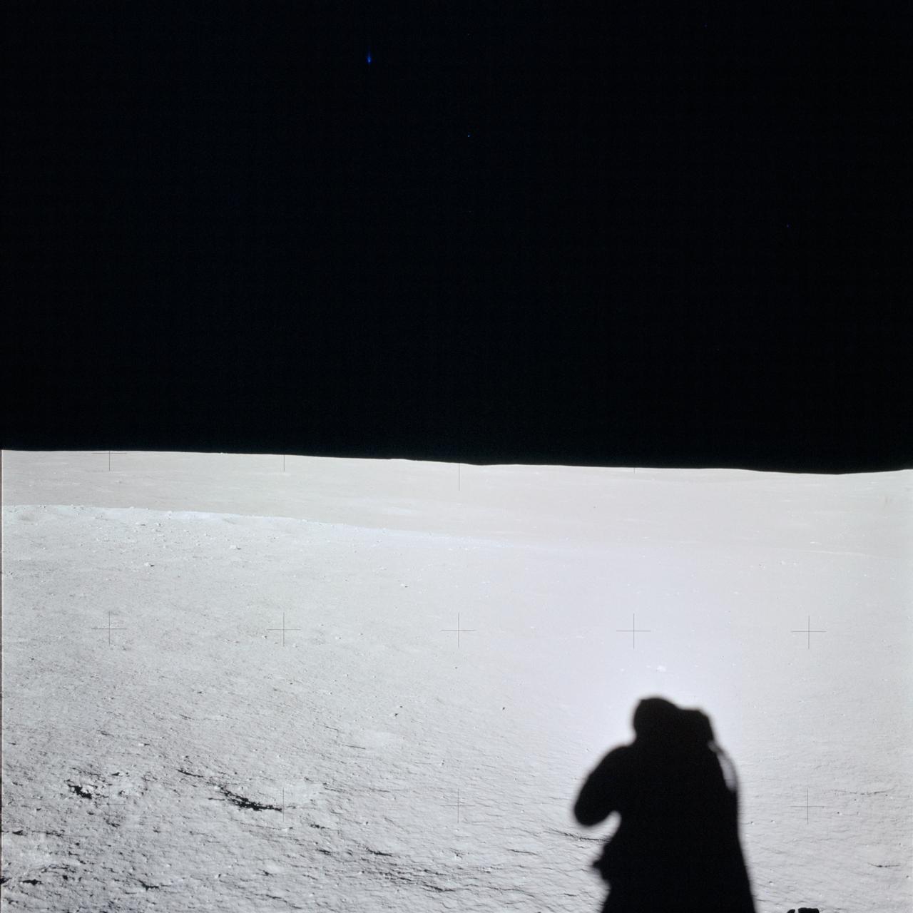 AS14-66-9293 (5 Feb. 1971) --- A portion of the Fra Mauro landing site as photographed by one of the Apollo 14 astronauts, standing slightly southwest of the Lunar Module (LM), during the early minutes of their first extravehicular activity (EVA) on the moon. The shadow of the astronaut taking the picture is at lower right. Photographs numbered AS14-66-9271 through AS14-66-9293 comprise a 360 degree panoramic view.