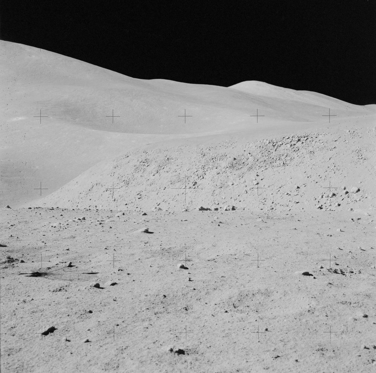 AS15-82-11123 (2 Aug. 1971) --- A view of the "strewn rock" scene encountered by Apollo 15 astronauts David R. Scott, commander, and James B. Irwin, lunar module pilot, during their third extravehicular activity (EVA) of the mission. Irwin took this photograph with a handheld 70mm camera. While astronauts Scott and Irwin descended in the Lunar Module (LM) "Falcon" to explore the moon, astronaut Alfred M. Worden, command module pilot, remained with the Command and Service Modules (CSM) in lunar orbit.
