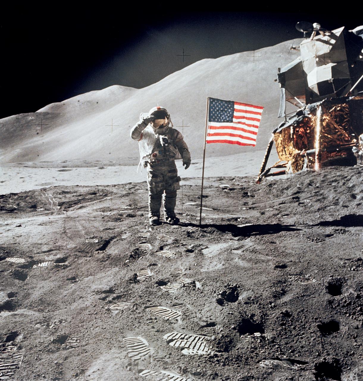 AS15-88-11863 (1 Aug. 1971) --- Astronaut David R. Scott, commander, gives a military salute while standing beside the deployed United States flag during the Apollo 15 lunar surface extravehicular activity (EVA) at the Hadley-Apennine landing site. The flag was deployed toward the end of EVA-2. The Lunar Module (LM), "Falcon," is partially visible on the right. Hadley Delta in the background rises approximately 4,000 meters (about 13,124 feet) above the plain. The base of the mountain is approximately 5 kilometers (about three statue miles) away. This photograph was taken by astronaut James B. Irwin, lunar module pilot. While astronauts Scott and Irwin descended in the LM to explore the moon, astronaut Alfred M. Worden, command module pilot, remained in lunar orbit in the Command and Service Modules (CSM).