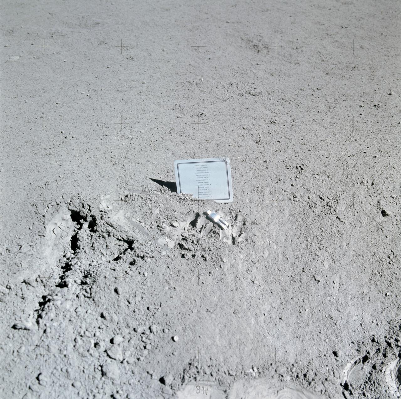 AS15-88-11894 (31 July-2 Aug. 1971) --- A close-up view of a commemorative plaque left on the moon at the Hadley-Apennine landing site in memory of 14 NASA astronauts and USSR cosmonauts, now deceased. Their names are inscribed in alphabetical order on the plaque. The plaque was stuck in the lunar soil by astronauts David R. Scott, commander, and James B. Irwin, lunar module pilot, during their Apollo 15 lunar surface extravehicular activity (EVA). The names on the plaque are Charles A. Bassett II, Pavel I. Belyayev, Roger B. Chaffee, Georgi Dobrovolsky, Theodore C. Freeman, Yuri A. Gagarin, Edward G. Givens Jr., Virgil I. Grissom, Vladimir Komarov, Viktor Patsayev, Elliot M. See Jr., Vladislav Volkov, Edward H. White II, and Clifton C. Williams Jr. The tiny, man-like object represents the figure of a fallen astronaut/cosmonaut. While astronauts Scott and Irwin descended in the Lunar Module (LM) "Falcon" to explore the Hadley-Apennine area of the moon, astronaut Alfred M. Worden, command module pilot, remained with the Command and Service Modules (CSM) in lunar orbit.