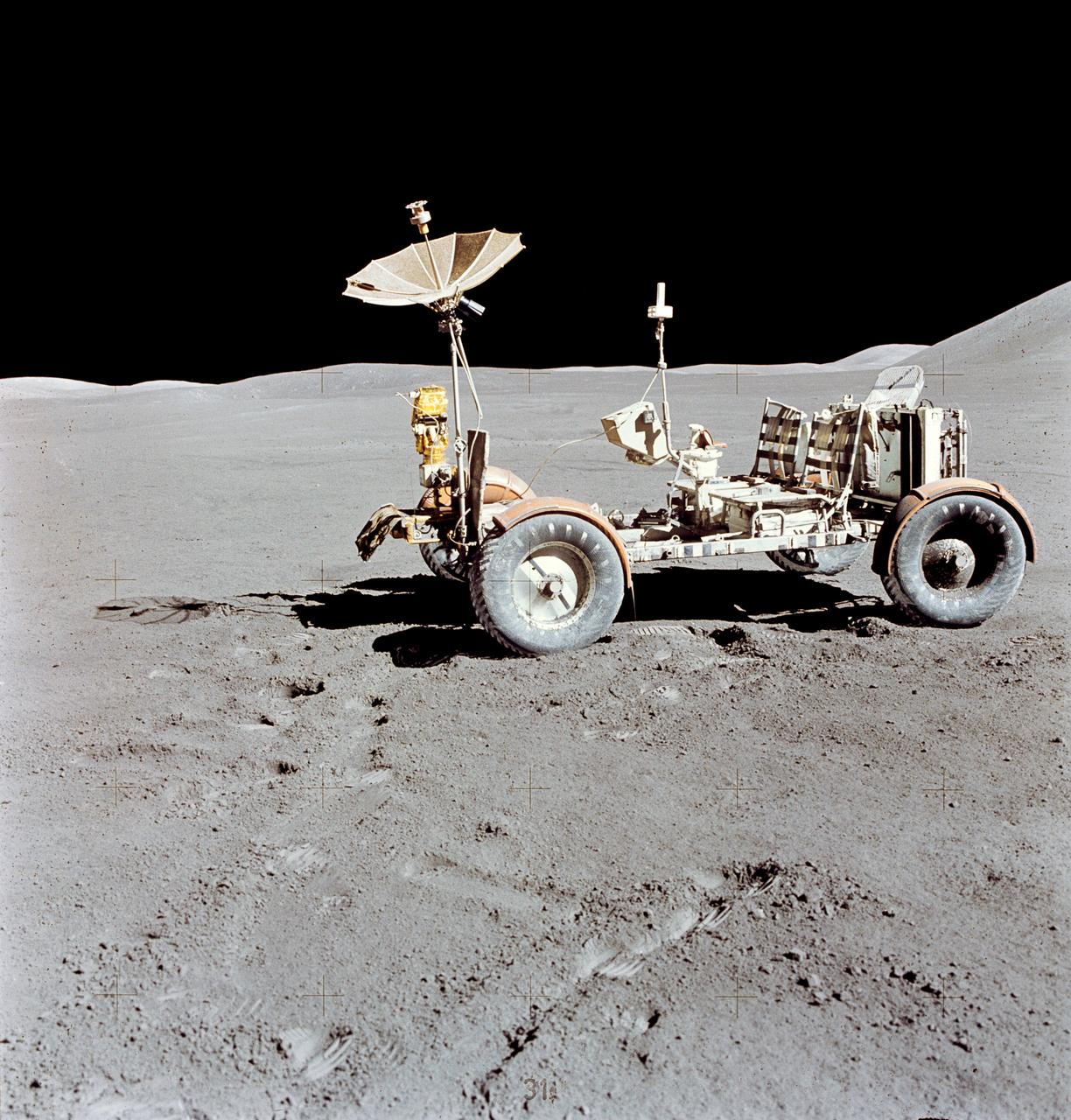 AS15-88-11901 (31 July-2 Aug. 1971) --- The Lunar Roving Vehicle (LRV) is photographed alone against the desolate lunar background during the third Apollo 15 lunar surface extravehicular activity (EVA) at the Hadley-Apennine landing site. This view is looking north. The west edge of Mount Hadley is at the upper right edge of the picture. Mount Hadley rises approximately 4,500 meters (about 4,765 feet) above the plain. The most distant lunar feature visible is approximately 25 kilometers (about 15.5 statute miles) away. While astronauts David R. Scott, commander; and James B. Irwin, lunar module pilot, descended in the Lunar Module (LM) "Falcon" to explore the moon, astronaut Alfred M. Worden, command module pilot, remained with the Command and Service Modules (CSM) in lunar orbit.