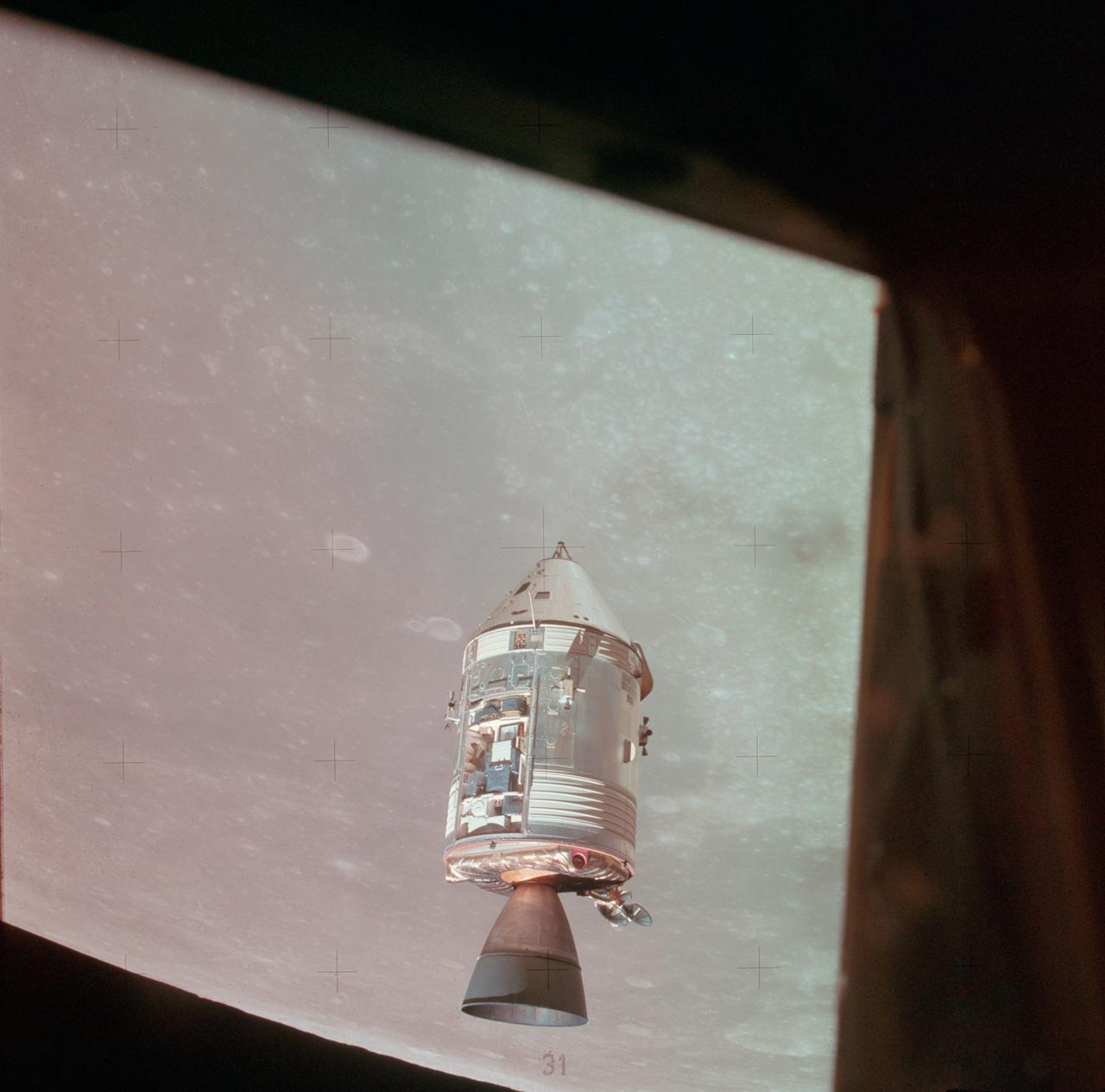 AS15-88-11968 (2 Aug. 1971) --- A view of the Apollo 15 Command and Service Modules (CSM) in lunar orbit as photographed from the Lunar Module (LM) "Falcon" just after rendezvous. The lunar features below are located on the east side of the Sea of Tranquility. While astronauts David R. Scott, commander; and James B. Irwin, lunar module pilot, descended in the LM to explore the moon, astronaut Alfred M. Worden, command module pilot, remained with the CSM in lunar orbit.