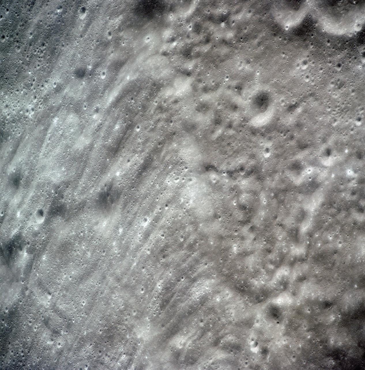 AS15-97-13168 (31 July-2 Aug. 1971) --- A view of the flow structure on the rim and edge of the crater Tsiolkovsky in the highlands of the lunar farside, as photographed from lunar orbit by astronaut Alfred M. Worden in the Apollo 15 Command and Service Module (CSM). Note the scarp at the edge of the flow and elongated grooves on the flow surface. While astronauts David R. Scott and James B. Irwin descended in the Lunar Module (LM) "Falcon" to explore the moon's Hadley-Apennine landing site, Worden remained with the CSM in lunar orbit.