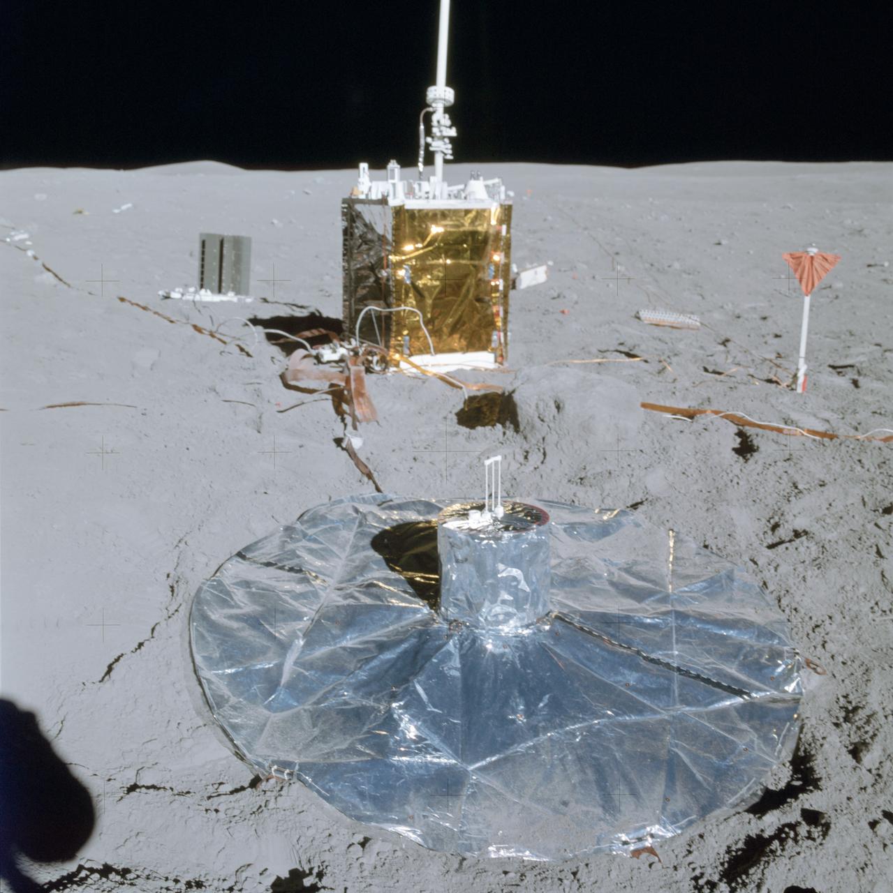 AS16-113-18347 (21 April 1972) --- A partial view of the Apollo 16 Apollo Lunar Surface Experiments Package (ALSEP) in deployed configuration on the lunar surface as photographed during the mission's first extravehicular activity (EVA), on April 21, 1972. The Passive Seismic Experiment (PSE) is in the foreground center; Central Station (C/S) is in center background, with the Radioisotope Thermoelectric Generator (RTG) to the left. One of the anchor flags for the Active Seismic Experiment (ASE) is at right. While astronauts John W. Young, commander; and Charles M. Duke Jr., lunar module pilot; descended in the Apollo 16 Lunar Module (LM) "Orion" to explore the Descartes highlands landing site on the moon, astronaut Thomas K. Mattingly II, command module pilot, remained with the Command and Service Modules (CSM) "Casper" in lunar orbit.