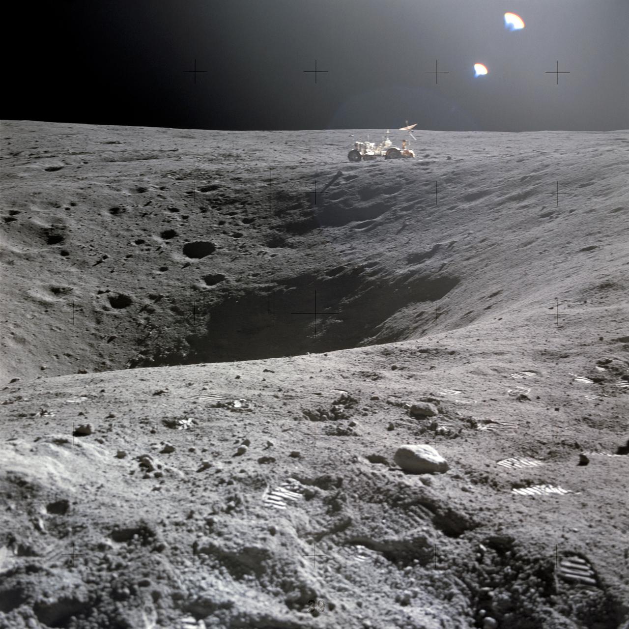 AS16-114-18422 (21 April 1972) --- A view of Plum Crater, which was visited by the two moon-exploring crewmen of the Apollo 16 lunar landing mission, on their first extravehicular activity (EVA) traverse, April 21, 1972. The Lunar Roving Vehicle (LRV) is parked on the far side of the crater, which measures approximately 40 meters in diameter. While astronauts John W. Young, commander; and Charles M. Duke Jr., lunar module pilot; descended in the Apollo 16 Lunar Module (LM) "Orion" to explore the Descartes highlands landing site on the moon, astronaut Thomas K. Mattingly II, command module pilot, remained with the Command and Service Modules (CSM) "Casper" in lunar orbit.