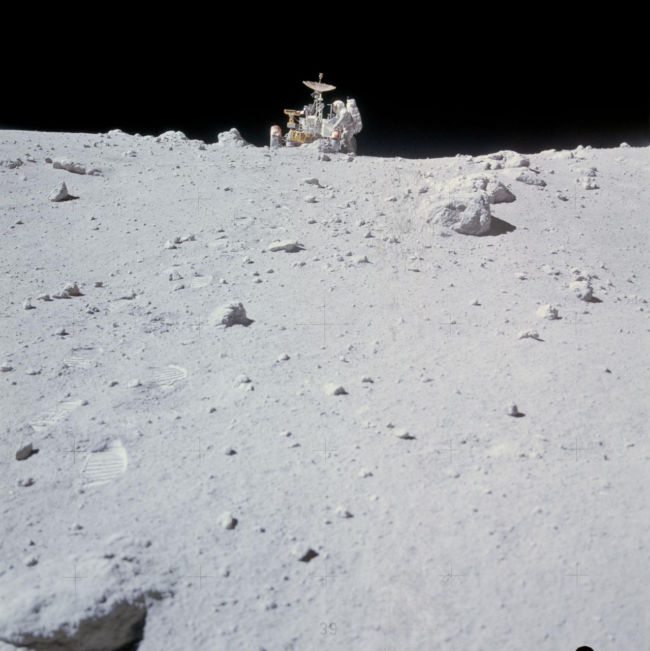 AS16-116-18607 (23 April 1972) --- Astronaut Charles M. Duke Jr. works at the front of the Lunar Roving Vehicle (LRV) parked in this rock field at a North Ray Crater geological site during the mission's third extravehicular activity (EVA) on April 23, 1972. Astronaut John W. Young took this picture with a 70mm Hasselblad camera. While astronauts Young, commander; and Duke, lunar module pilot; descended in the Apollo 16 Lunar Module (LM) "Orion" to explore the Descartes highlands landing site on the moon, astronaut Thomas K. Mattingly II, command module pilot, remained with the Command and Service Modules (CSM) "Casper" in lunar orbit.
