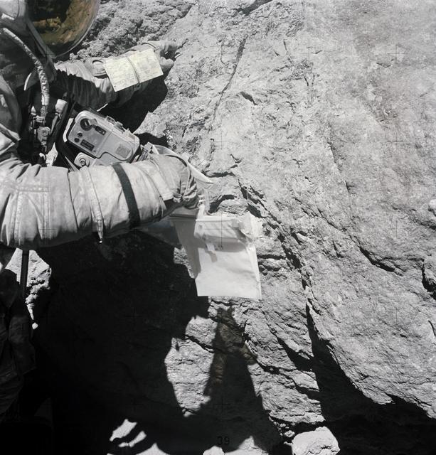 NASA image: Astronaut Charles Duke examines surface of boulder at North Ray crater
