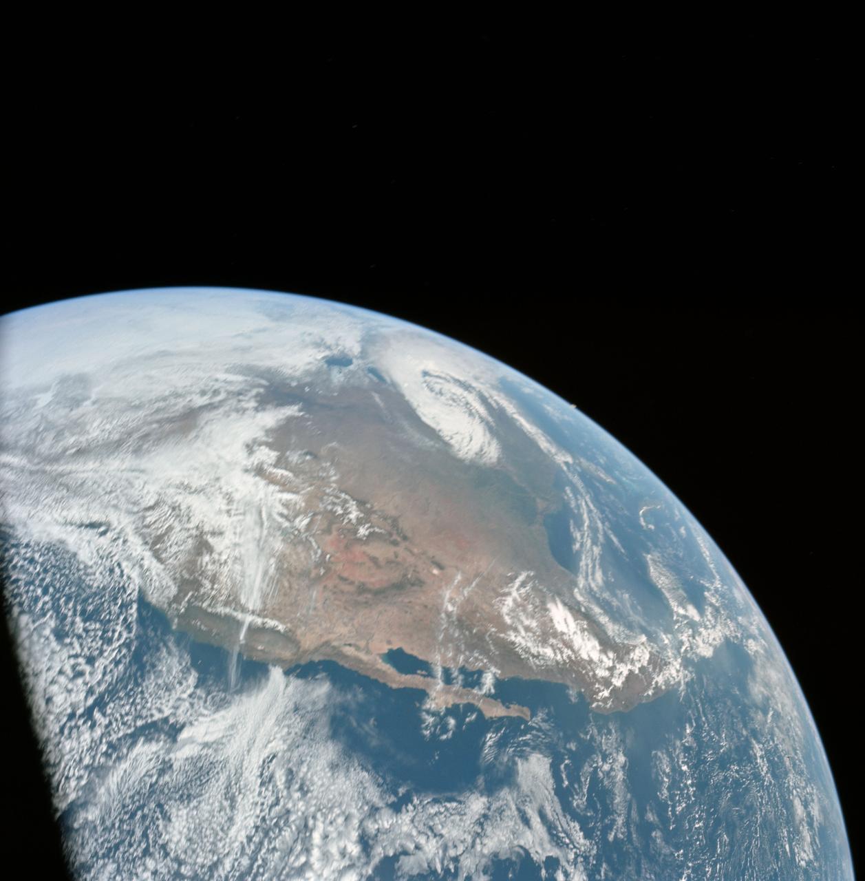 AS16-118-18873 (16 April 1972) --- A good view of Earth photographed shortly after trans-lunar injection of April 16, 1972. Although there is much cloud cover (over Canada and the oceans), the United States in large part, most of Mexico and some parts of Central America are clearly visible. Note Lake Michigan and Lake Superior, also note the Bahama Banks at upper right part of the sphere. A large part of the Rocky Mountain Range is also visible. Just beginning man's fifth lunar landing mission were astronauts John W. Young, commander; Thomas K. Mattingly II, command module pilot; and Charles M. Duke Jr., lunar module pilot. While astronauts Young and Duke descended in the Lunar Module (LM) to explore the moon, astronaut Mattingly remained with the Command and Service Modules (CSM) in lunar orbit.