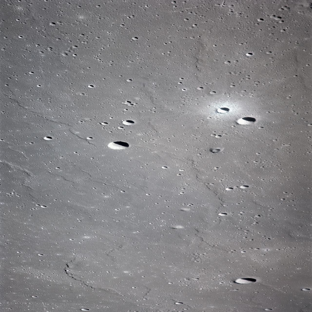 AS16-120-19237 (April 1972) --- An oblique view of a portion of the lunar nearside as photographed from the Apollo 16 spacecraft in lunar orbit. The small, bright crater is Lassell D at the northeastern edge of Mare Nubium (Sea of Clouds). The area seen in this picture is immediately west of Lassell C Crater, southwest of Guoricke Crater, and southwest of Davy Crater.