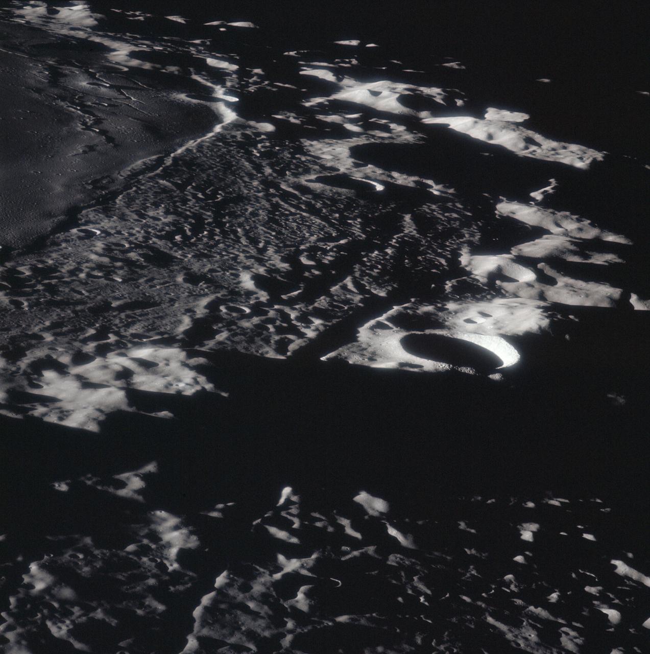 AS16-120-19332 (April 1972) --- This picture of the lunar surface was photographed from lunar orbit during the Apollo 16 lunar landing mission. Mersenius C Crater, dozens of smaller craters and several small rille features can be seen in the frame. Center point coordinates are located at 19.5 degrees south latitude and 45 degrees west longitude. While astronauts John W. Young, commander; and Charles M. Duke Jr., lunar module pilot; descended in the Apollo 16 Lunar Module (LM) "Orion" to explore the Descartes highlands landing site on the moon, astronaut Thomas K. Mattingly II, command module pilot, remained with the Command and Service Modules (CSM) "Casper" in lunar orbit.
