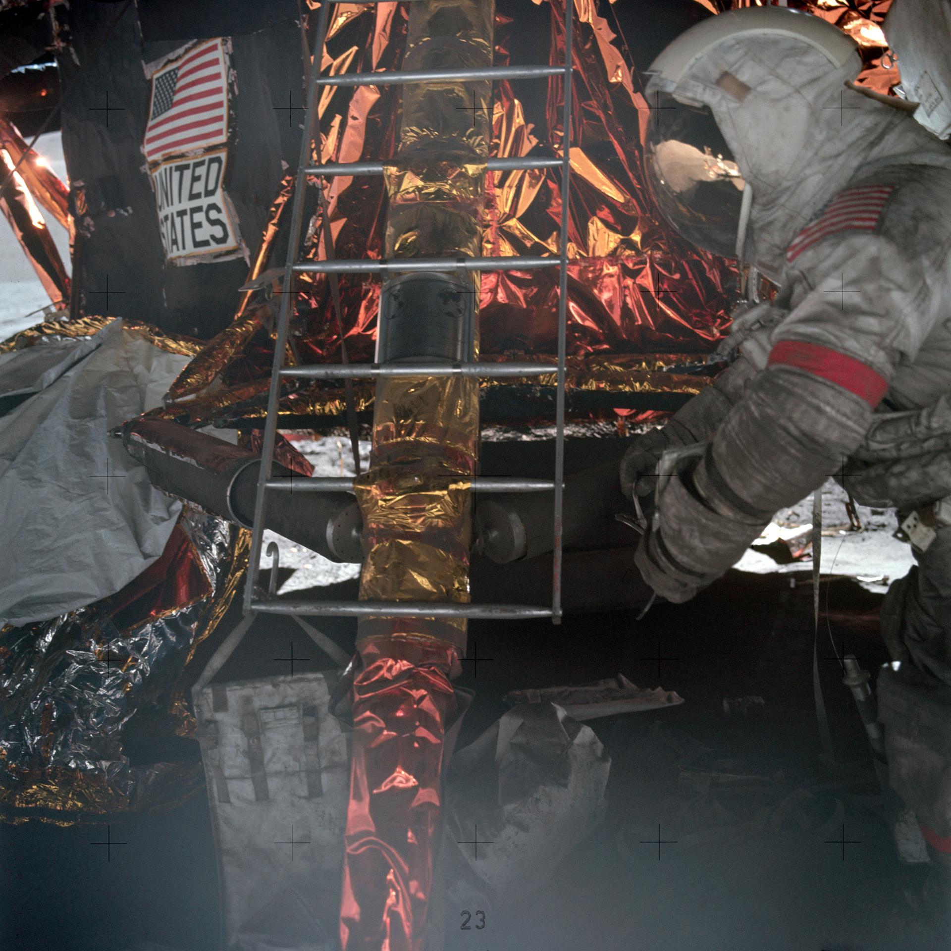 An Apollo astronaut preparing to climb the ladder into the lunar module's ascent stage, his spacesuit is covered in lunar dust.