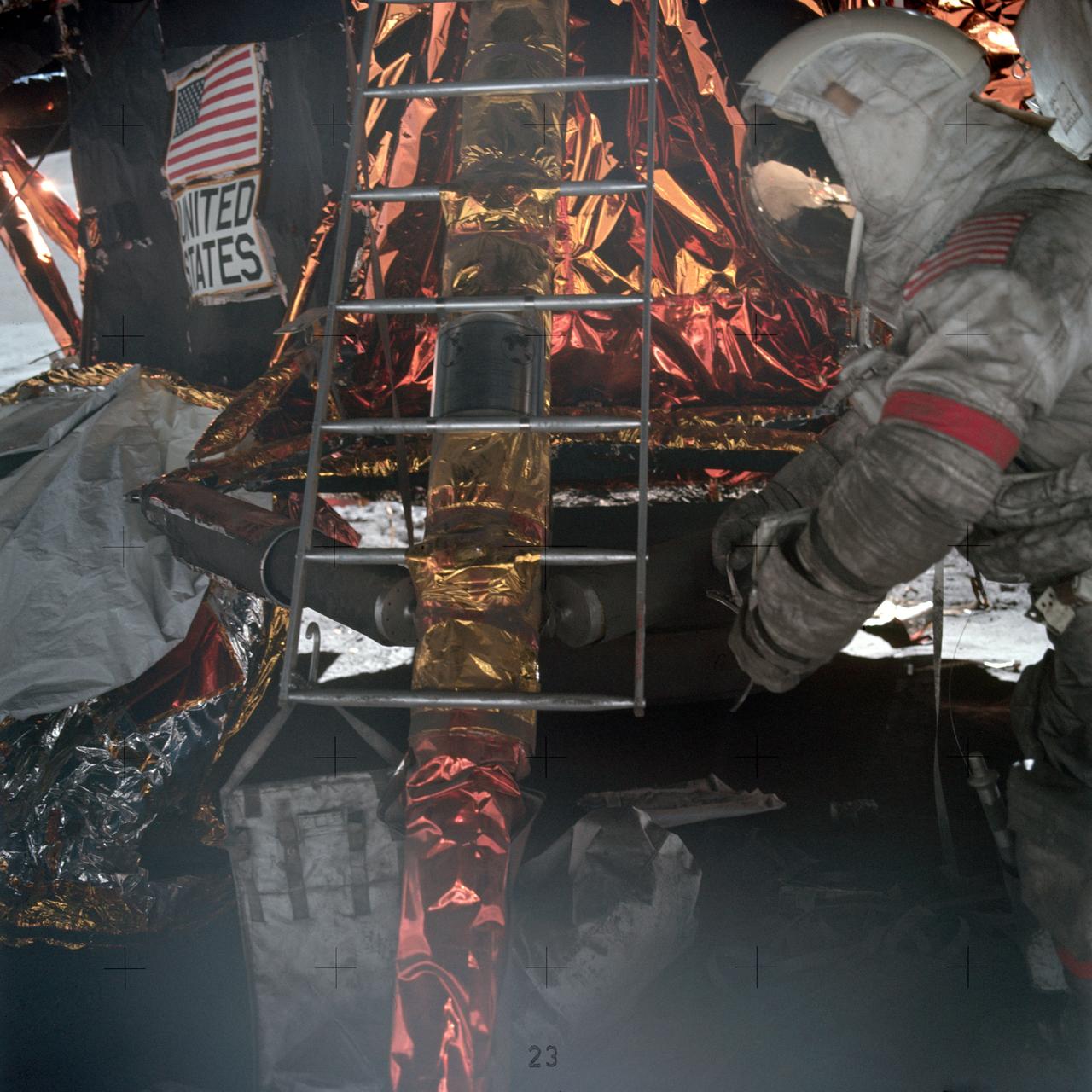 Astronaut Eugene A. Cernan, Apollo 17 commander, prepares to mount ladder to lunar module ascent stage. Note the plaque attached to the ladder which will be left with the descent stage when the mission lifts off from the lunar surface.