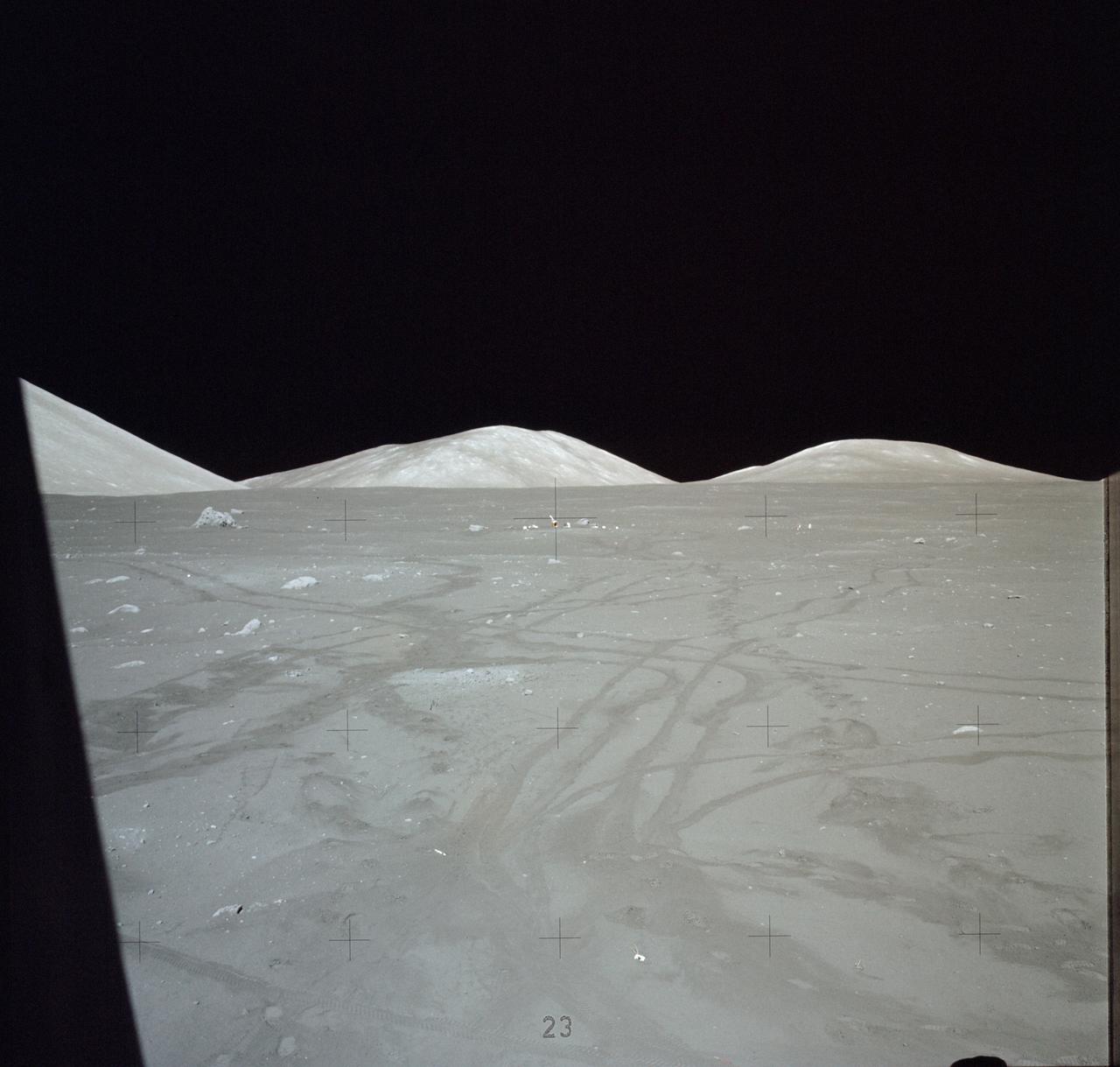 AS17-140-21355 (7-19 Dec. 1972) --- This picture of the lunar surface was taken from the window of the lunar module at the Taurus-Littrow landing site. Astronauts Eugene A. Cernan and Harrison H. Schmitt were inside the lunar module preparing for the mission's third spacewalk. Tracks made by lunar roving vehicle (LRV) and the astronauts' bootprints from earlier spacewalks are seen in the foreground.