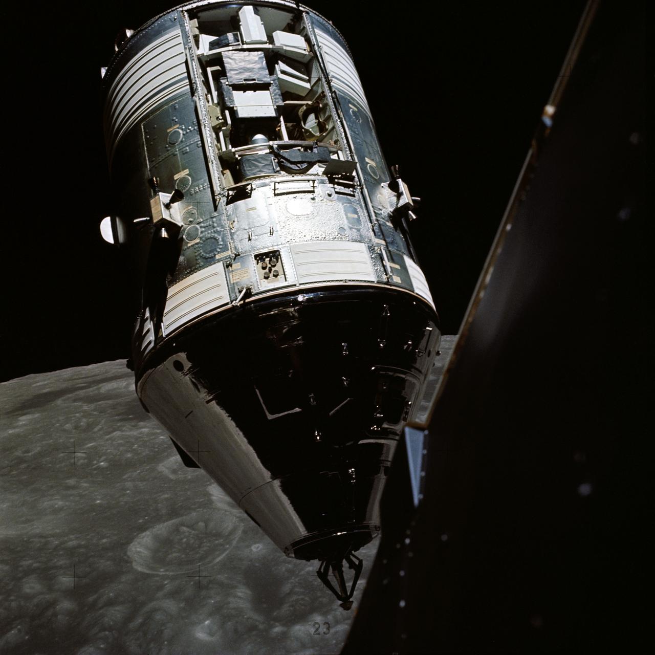 AS17-145-22254 (14 Dec. 1972) --- An excellent view of the Apollo 17 Command and Service Modules (CSM) photographed from the Lunar Module (LM) "Challenger" during rendezvous and docking maneuvers in lunar orbit. The LM ascent stage, with astronauts Eugene A. Cernan and Harrison H. Schmitt aboard, had just returned from the Taurus-Littrow landing site on the lunar surface. Astronaut Ronald E. Evans remained with the CSM in lunar orbit. Note the exposed Scientific Instrument Module (SIM) Bay in Sector 1 of the Service Module (SM). Three experiments are carried in the SIM bay: S-209 lunar sounder, S-171 infrared scanning spectrometer, and the S-169 far-ultraviolet spectrometer. Also mounted in the SIM bay are the panoramic camera, mapping camera and laser altimeter used in service module photographic tasks. A portion of the LM is on the right.
