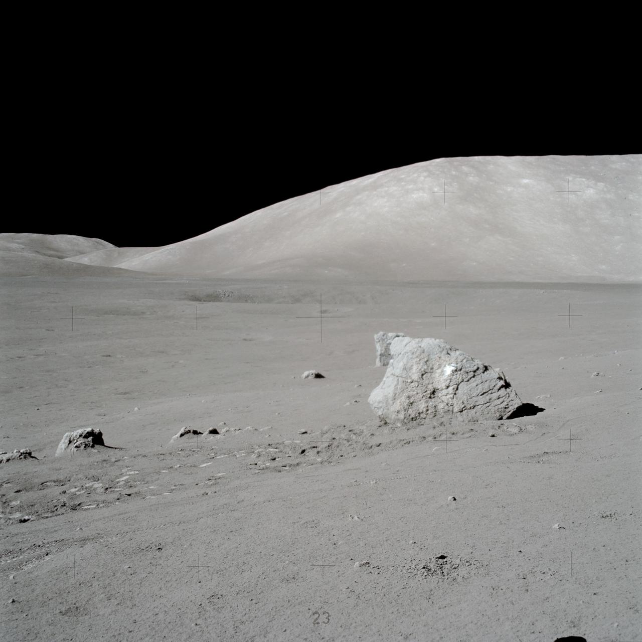 AS17-146-22351 (7-19 Dec. 1972) --- This view, photographed by astronaut Eugene A. Cernan, shows a large boulder which was discovered by astronauts Cernan and Harrison H. Schmitt during one of their space walks. The astronauts later pointed out light clasts on the boulder. South Massif is in the background. Tracks left by the Lunar Roving Vehicle (LRV) can be seen near foreground. While astronauts Cernan, commander, and Schmitt, lunar module pilot, descended in the Lunar Module (LM) "Challenger" to explore the Taurus-Littrow region of the moon, astronaut Ronald E. Evans, command module pilot, remained with the Command and Service Modules (CSM) "America" in lunar orbit.