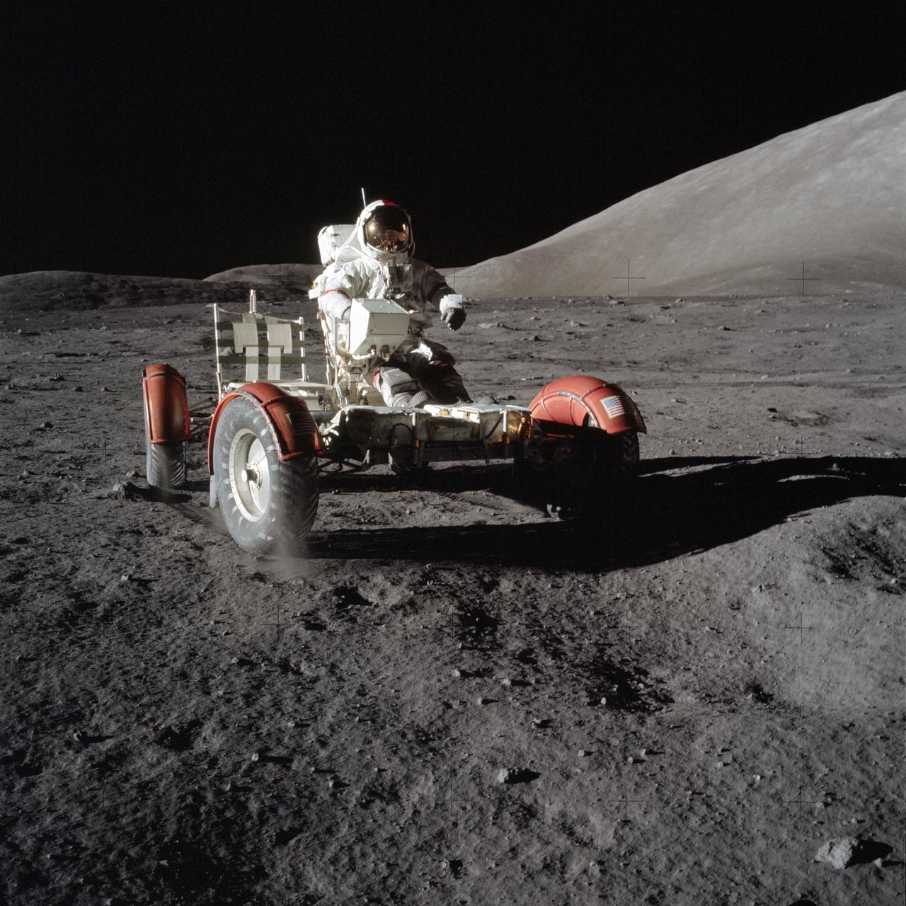 AS17-147-22526 (11 Dec. 1972) --- Astronaut Eugene A. Cernan, commander, makes a short checkout of the Lunar Roving Vehicle (LRV) during the early part of the first Apollo 17 extravehicular activity (EVA) at the Taurus-Littrow landing site. This view of the "stripped down" LRV is prior to loading up. Equipment later loaded onto the LRV included the ground-controlled television assembly, the lunar communications relay unit, hi-gain antenna, low-gain antenna, aft tool pallet, lunar tools and scientific gear. This photograph was taken by scientist-astronaut Harrison H. Schmitt, lunar module pilot. The mountain in the right background is the east end of South Massif. While astronauts Cernan and Schmitt descended in the Lunar Module (LM) "Challenger" to explore the moon, astronaut Ronald E. Evans, command module pilot, remained with the Command and Service Modules (CSM) "America" in lunar orbit.