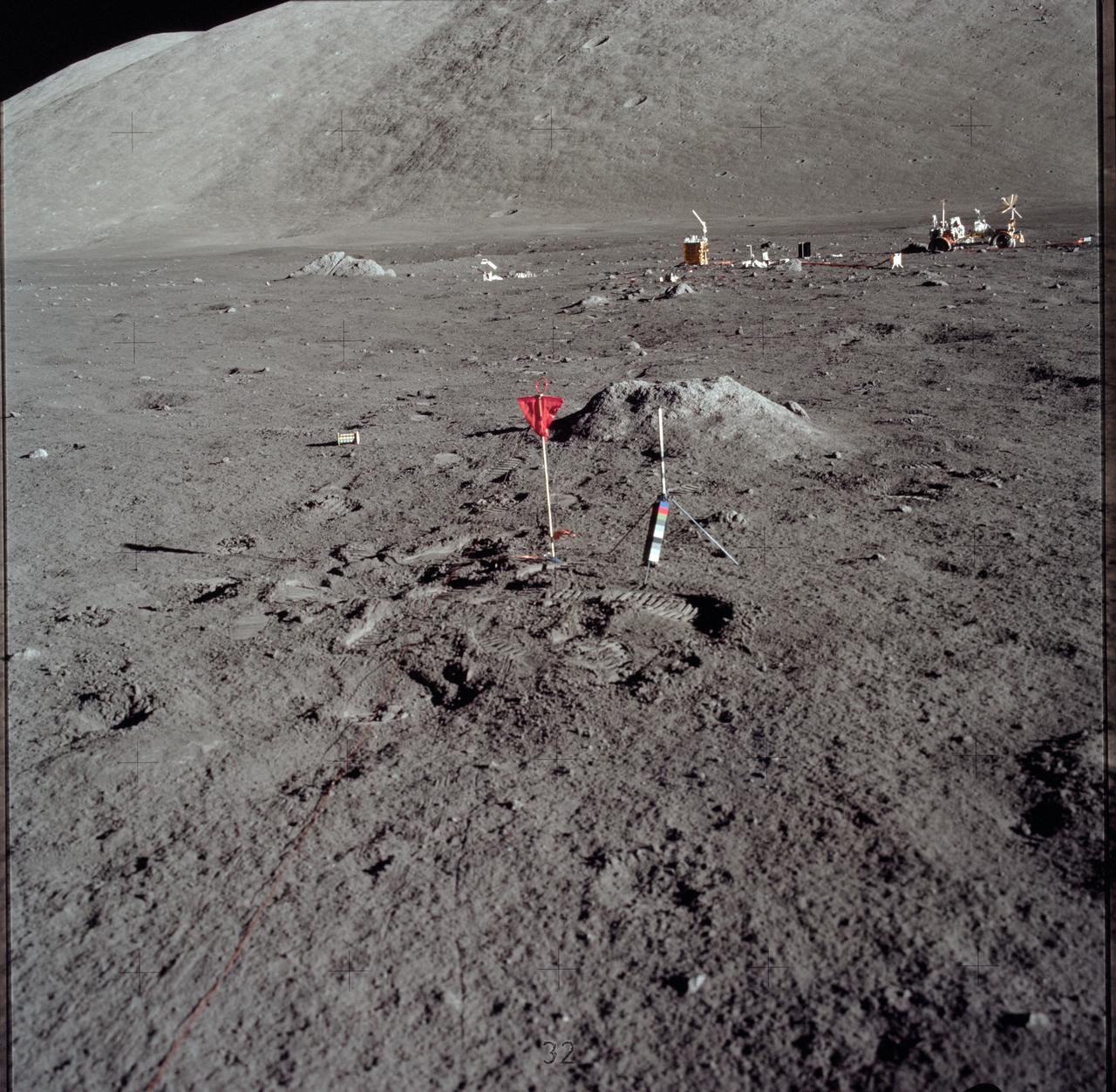 AS17-147-22548 (11 Dec. 1972) --- This is a photograph of the LSP geosphere flag on the lunar surface. The gnomon is in the foreground, while Apollo Lunar Scientific Experiments Package (ALSEP) and north Massif is in the background. The Lunar Roving Vehicle (LRV) is also seen in the right background. While astronauts Eugene A. Cernan, commander, and Harrison H. Schmitt, lunar module pilot, descended in the Lunar Module (LM) "Challenger" to explore the Taurus-Littrow region of the moon, astronaut Ronald E. Evans, command module pilot, remained with the Command and Service Modules (CSM) "America" in lunar orbit.