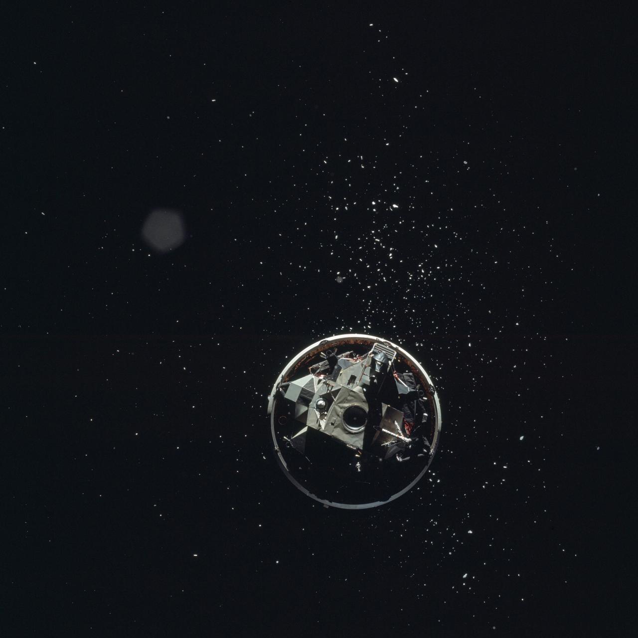 AS17-148-22688 (7-19 Dec. 1972) --- View of the Lunar Module from the Apollo 17 spacecraft after transposition/docking maneuvers. The white dots surrounding the Lunar Module are debris from the Saturn S-IVB stage separation.