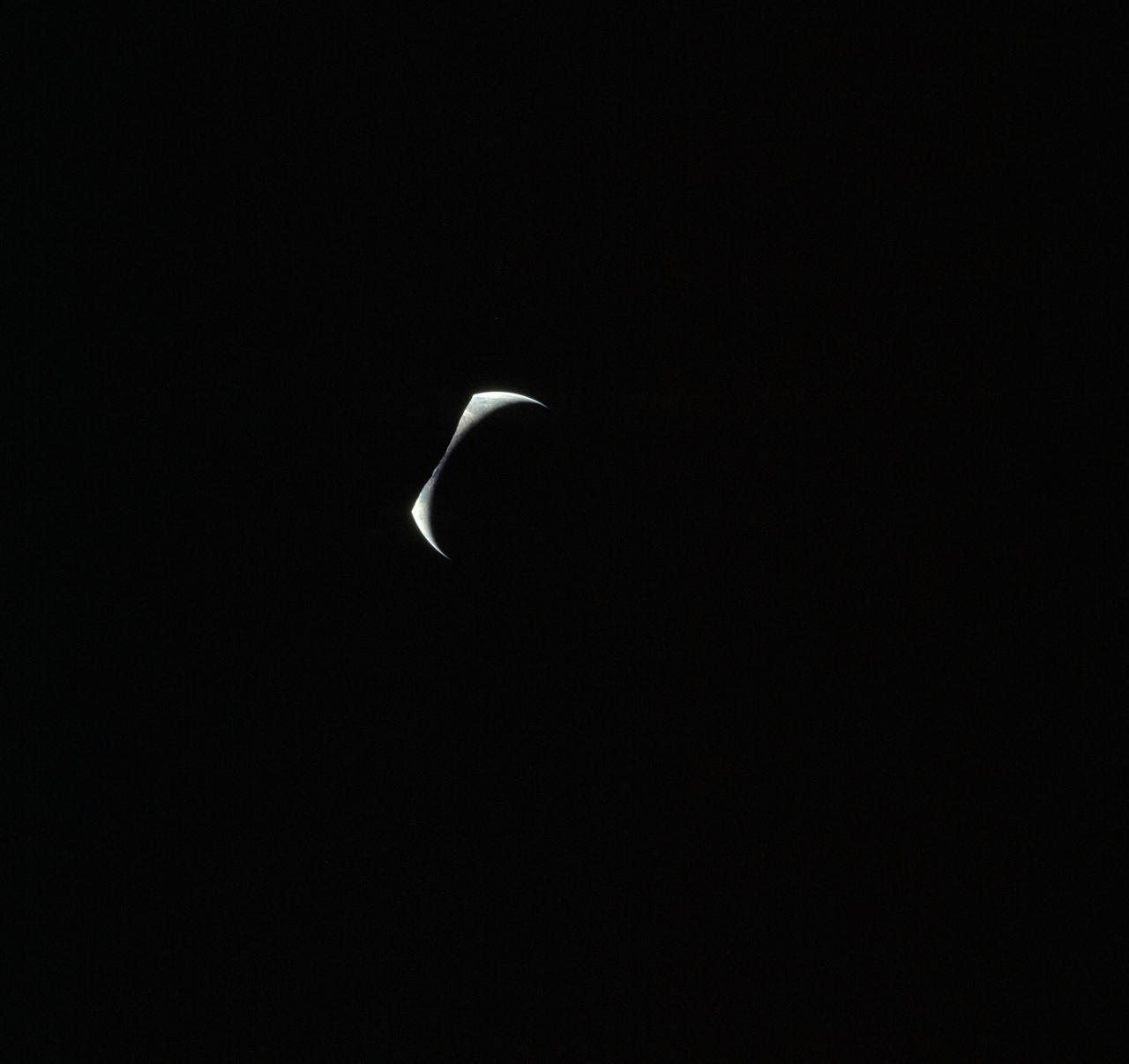 AS17-152-23279 (7-19 Dec. 1972) --- Eclipsed by the silhouetted horizon of the moon, the crescent Earth appears in the shape of a Viking's headwear in this unusual Apollo 17 photograph. The three astronauts--Eugene A. Cernan, Ronald E. Evans and Harrison H. Schmitt--were just about to begin their journey homeward following the successful lunar landing phase of their mission.