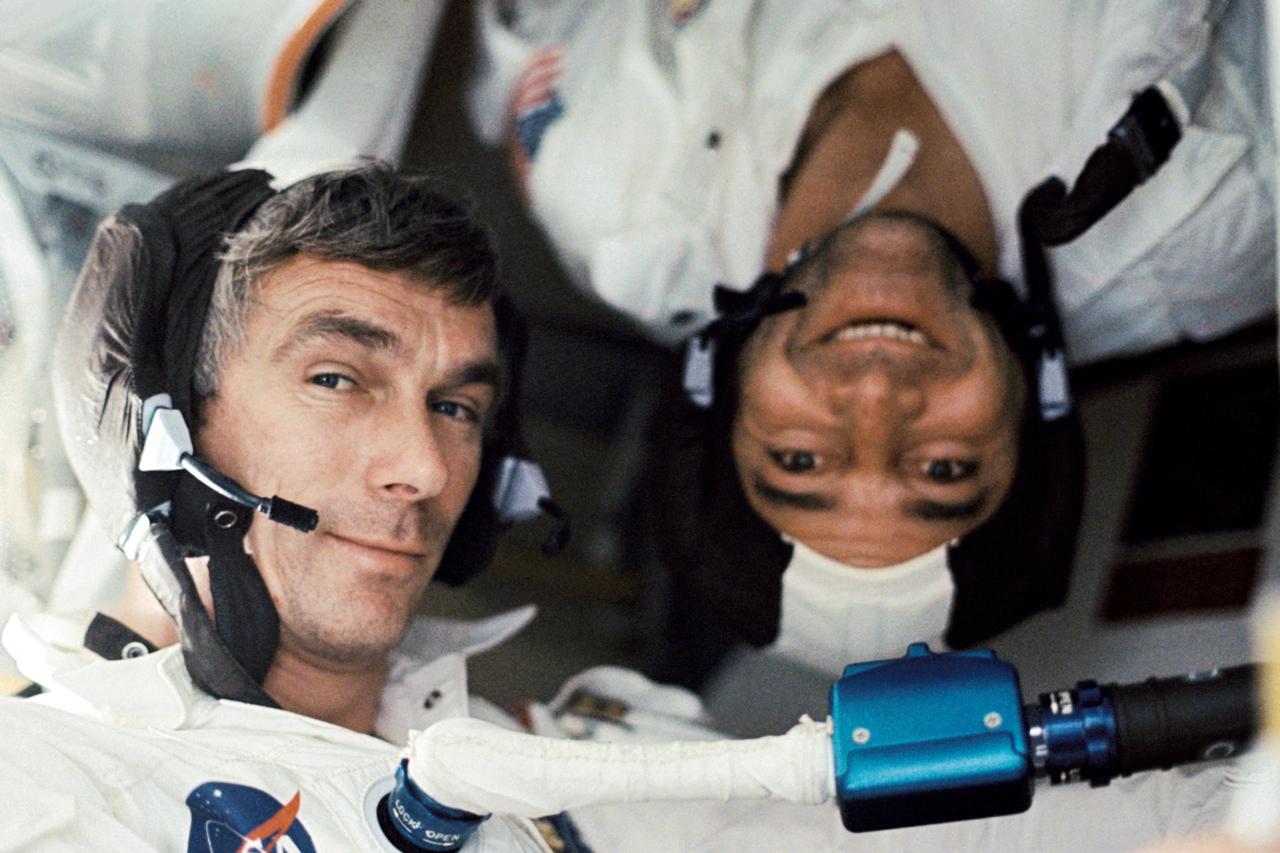 AS17-162-24053 (7-19 Dec. 1972) --- Scientist-astronaut Harrison H. "Jack" Schmitt, lunar module pilot, took this photograph of his two fellow crew men under zero-gravity conditions aboard the Apollo 17 spacecraft during the final lunar landing mission in NASA's Apollo program. That is astronaut Eugene A. Cernan, commander, who is seemingly "right side up." Astronaut Ronald E. Evans, command module pilot, appears to be "upside down." While astronauts Cernan and Schmitt descended in the Lunar Module (LM) "Challenger" to explore the Taurus-Littrow region of the moon, astronaut Evans remained with the Command and Service Modules (CSM) "America" in lunar orbit.