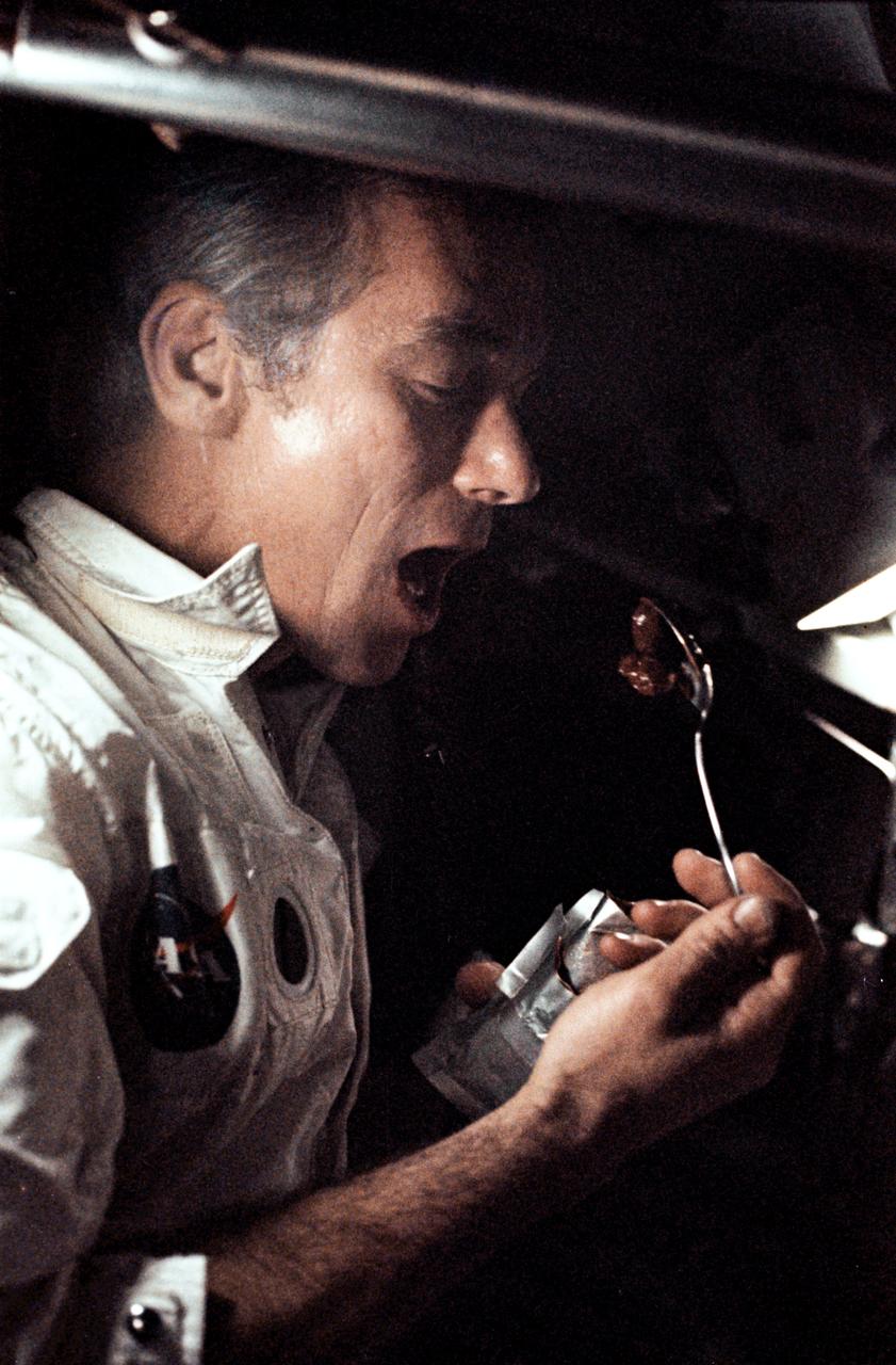 AS17-163-24129 (7-19 Dec. 1972) --- A fellow crewman took this photograph of astronaut Eugene A. Cernan eating a meal under weightlessness conditions of space during the final lunar landing mission in NASA's Apollo program. Also, aboard the Apollo 17 spacecraft were astronaut Ronald E. Evans, command module pilot, and scientist-astronaut Harrison H. "Jack" Schmitt, lunar module pilot. Cernan was the mission commander.