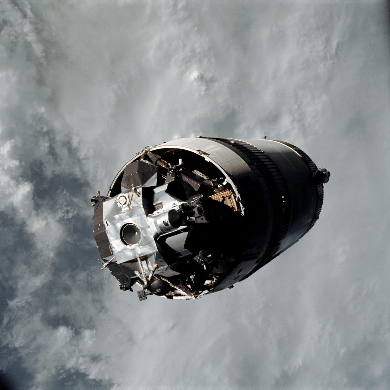 AS09-19-2919 (3 March 1969) --- The Lunar Module (LM) "Spider", still attached to the Saturn V third (S-IVB) stage, is photographed from the Command and Service Modules (CSM) "Gumdrop" on the first day of the Apollo 9 Earth-orbital mission. This picture was taken following CSM/LM-S-IVB separation and prior to LM extraction from the S-IVB. The Spacecraft Lunar Module Adapter (SLA) panels have already been jettisoned. Inside the Command Module were astronauts James A. McDivitt, commander; David R. Scott, command module pilot; and Russell L. Schweickart, lunar module pilot.
