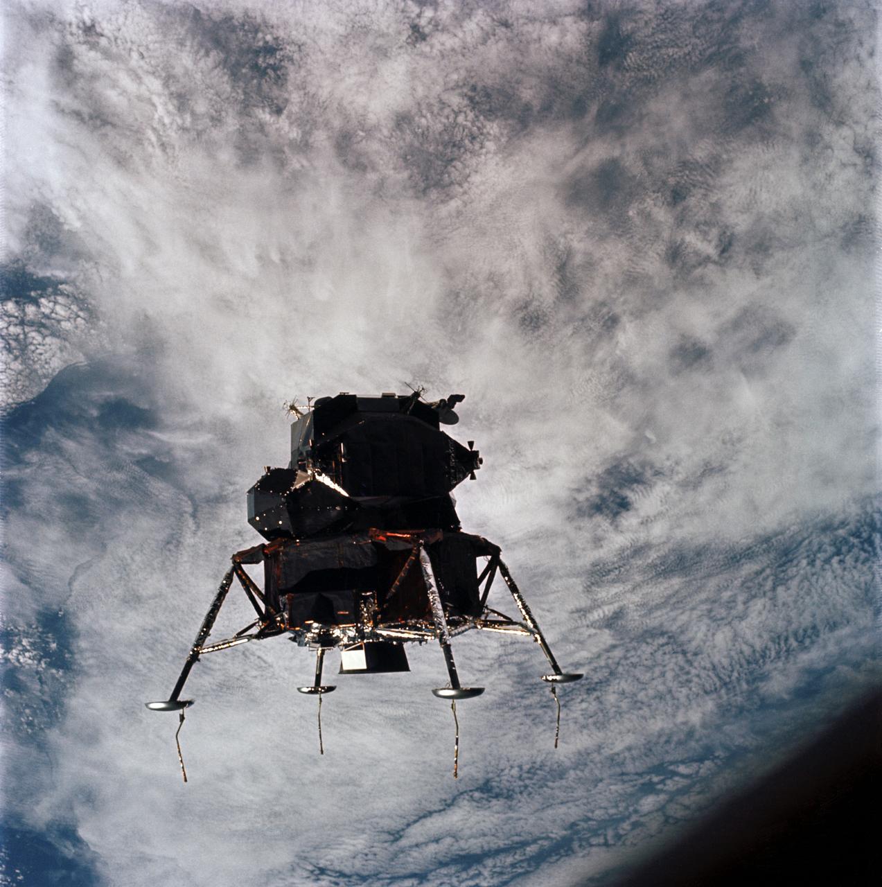 AS09-21-3199 (7 March 1969) --- Excellent view of the Apollo 9 Lunar Module, "Spider," in a lunar landing configuration, as photographed from the Command and Service Modules on the fifth day of the Apollo 9 Earth-orbital mission. The landing gear on the "Spider" has been deployed. Lunar surface probes (sensors) extend out from the landing gear foot pads. Inside the "Spider" were astronauts James A. McDivitt, Apollo 9 commander; and Russell L. Schweickart, lunar module pilot. Astronaut David R. Scott, command module pilot, remained at the controls in the Command Module, "Gumdrop," while the other two astronauts checked out the Lunar Module.